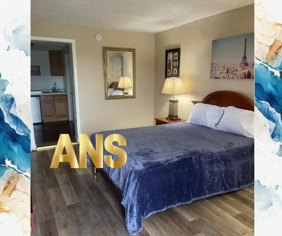 Bed in ANS INN & SUITES