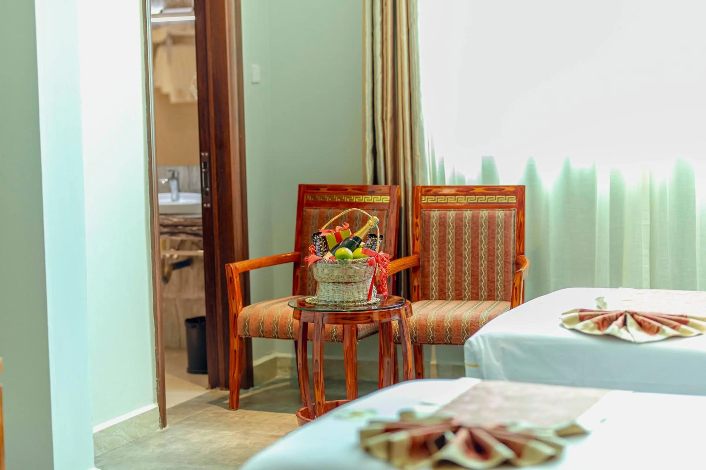 Seating area, Bed in Tiffany Diamond Hotels LTD - Makunganya