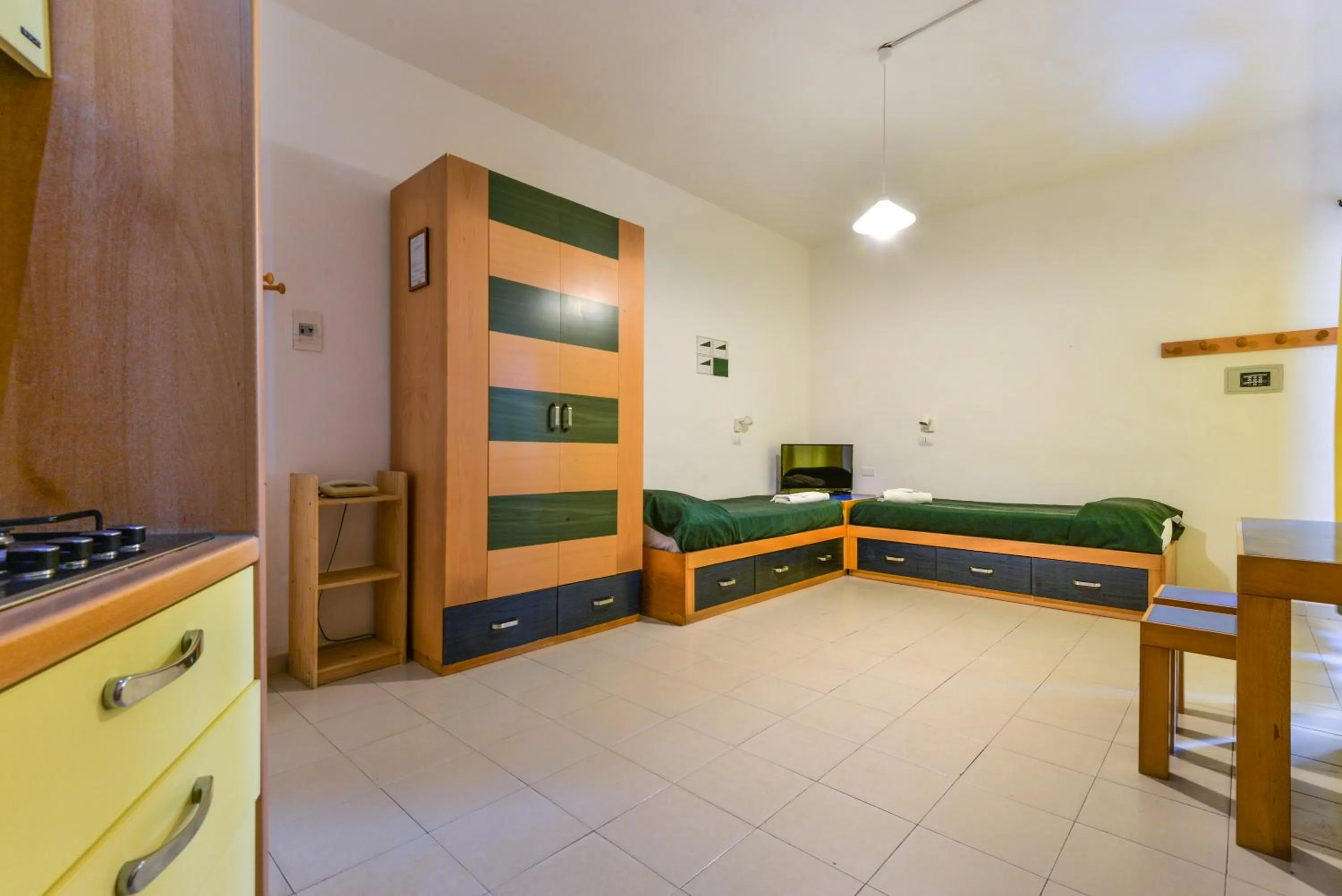 Living room, Bed in Residence Le Acacie