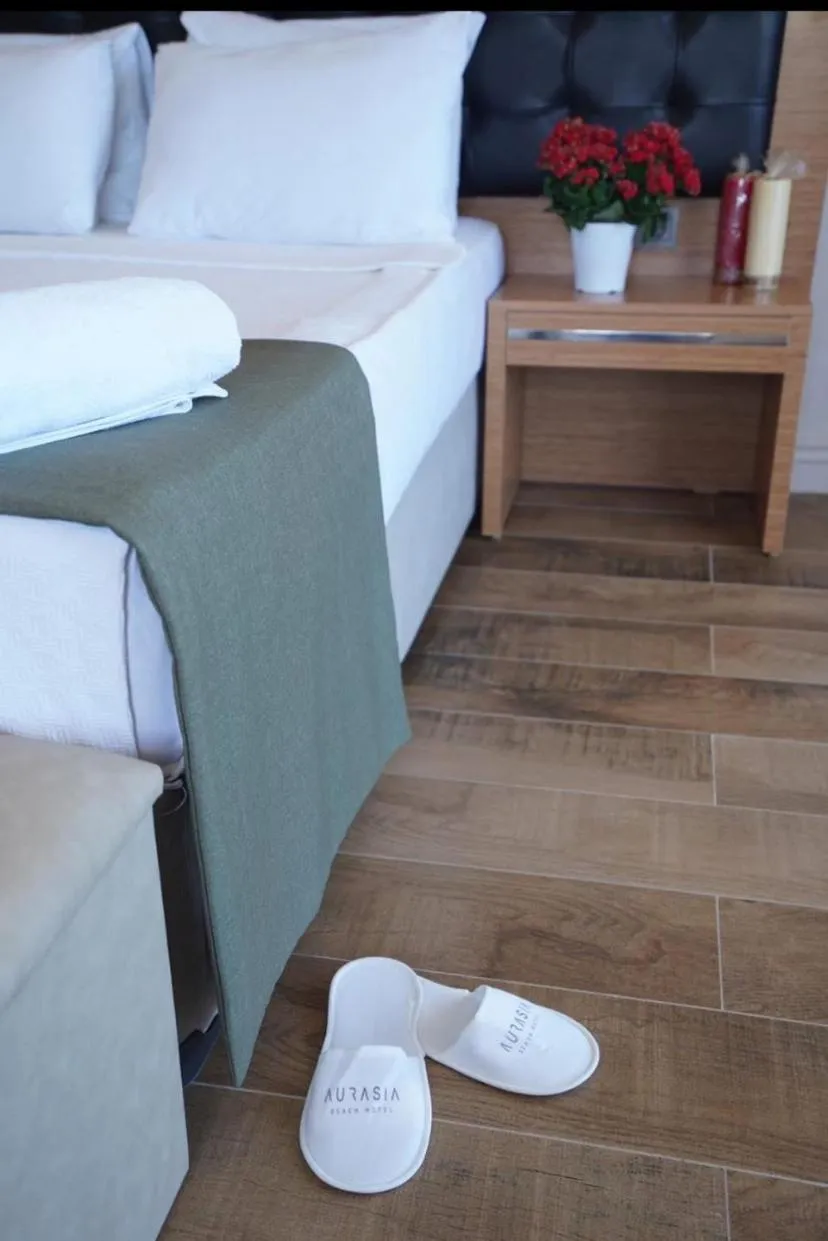 Bed in Aurasia Sea Side Hotel
