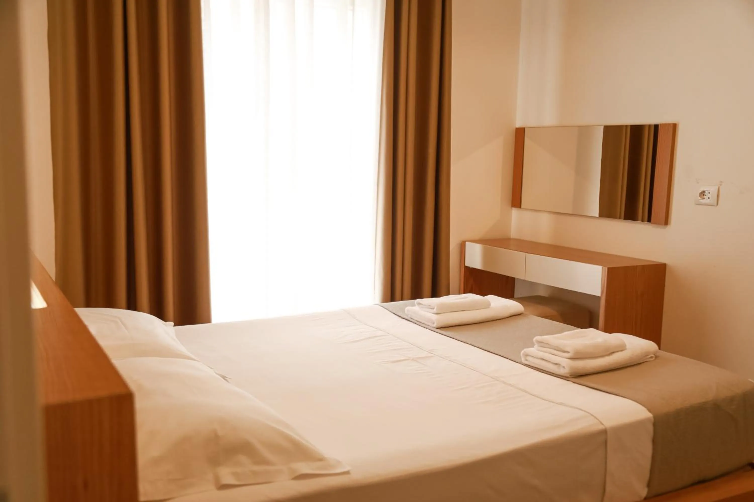 Bed in Sunrise Luxury Apartments