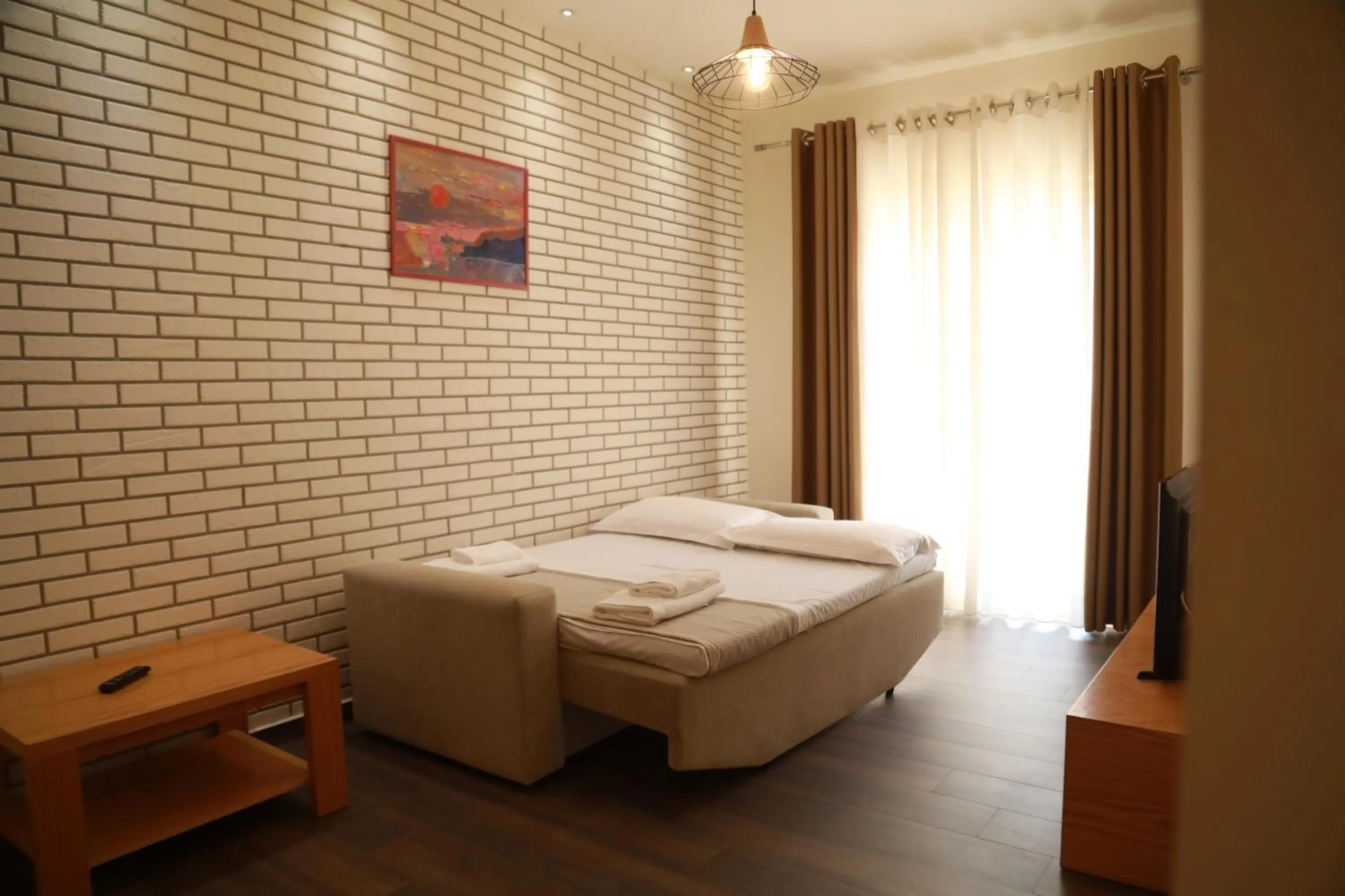 Bed in Sunrise Luxury Apartments