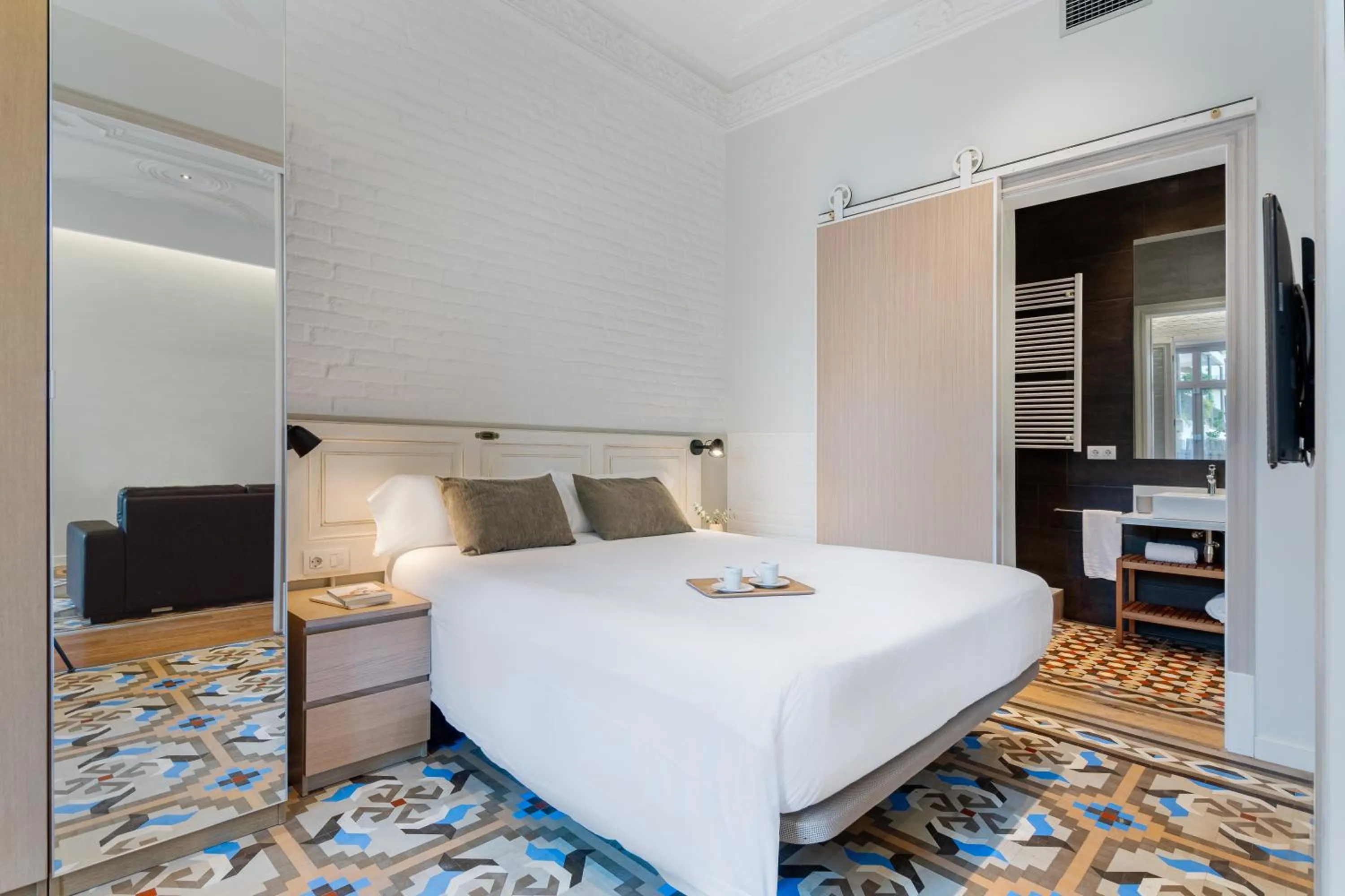 Bed in Fuster Apartments by Aspasios