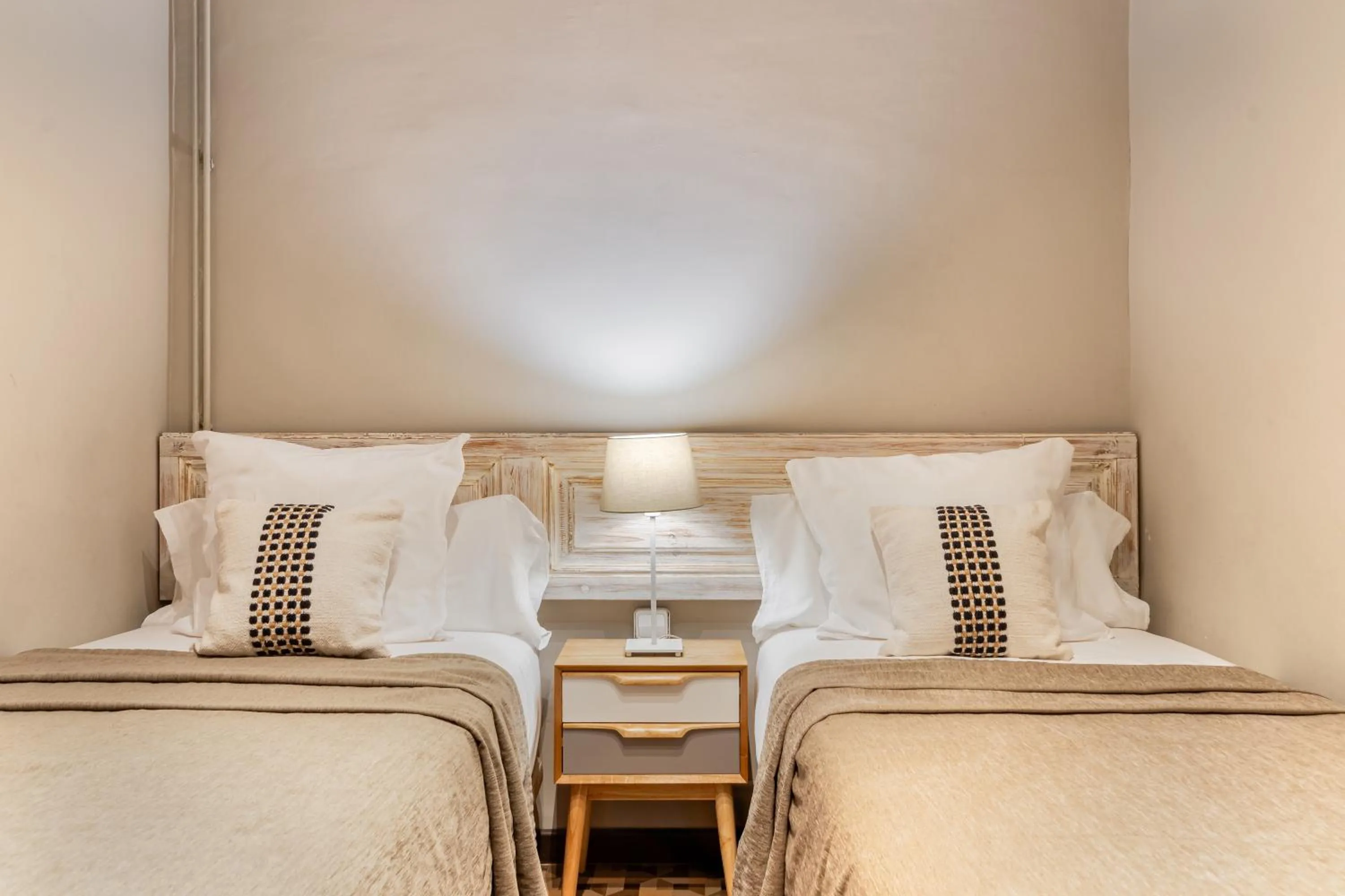 Bed in Fuster Apartments by Aspasios