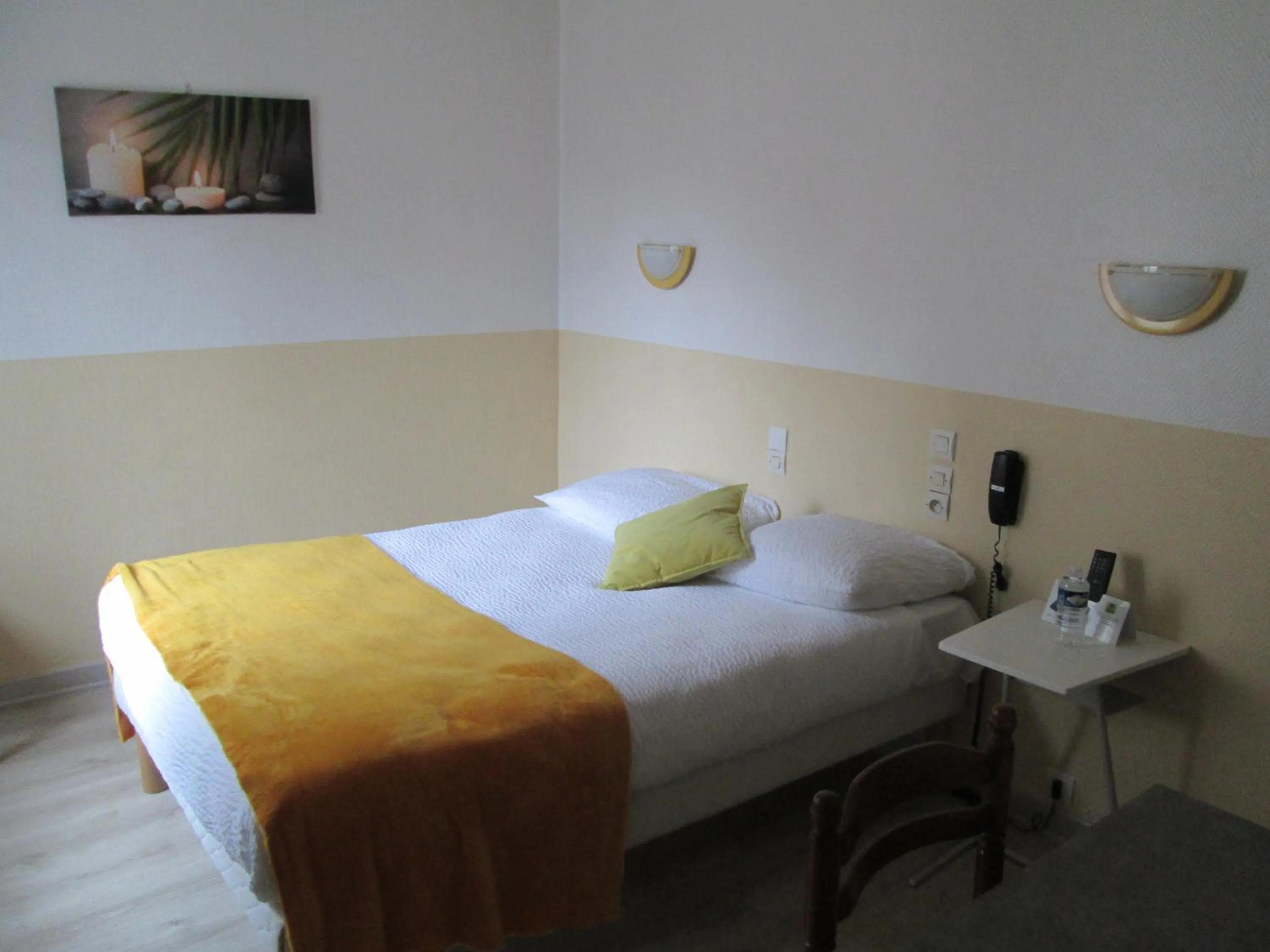 Bed in Logis Hôtel Beauséjour