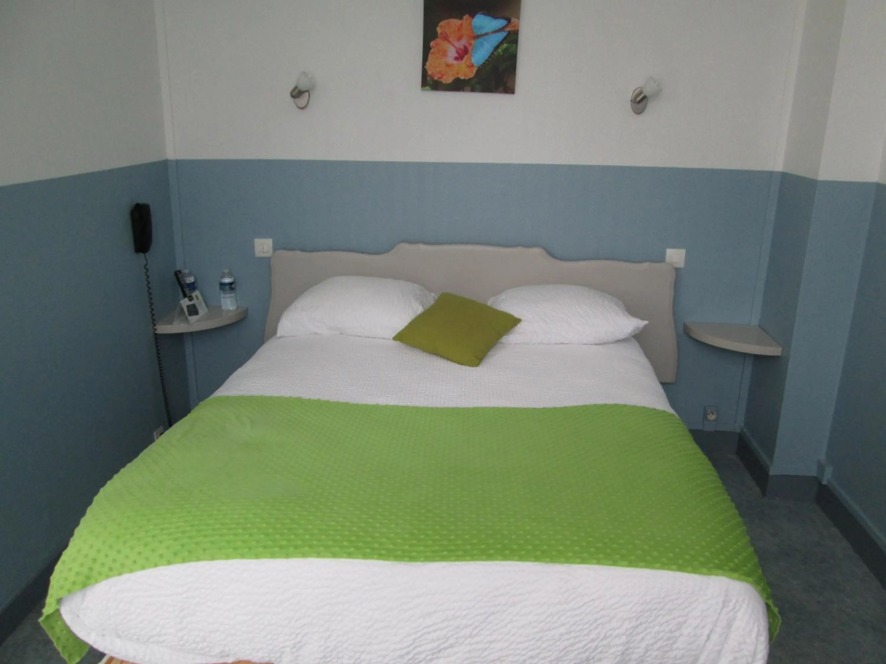 Bed in Logis Hôtel Beauséjour