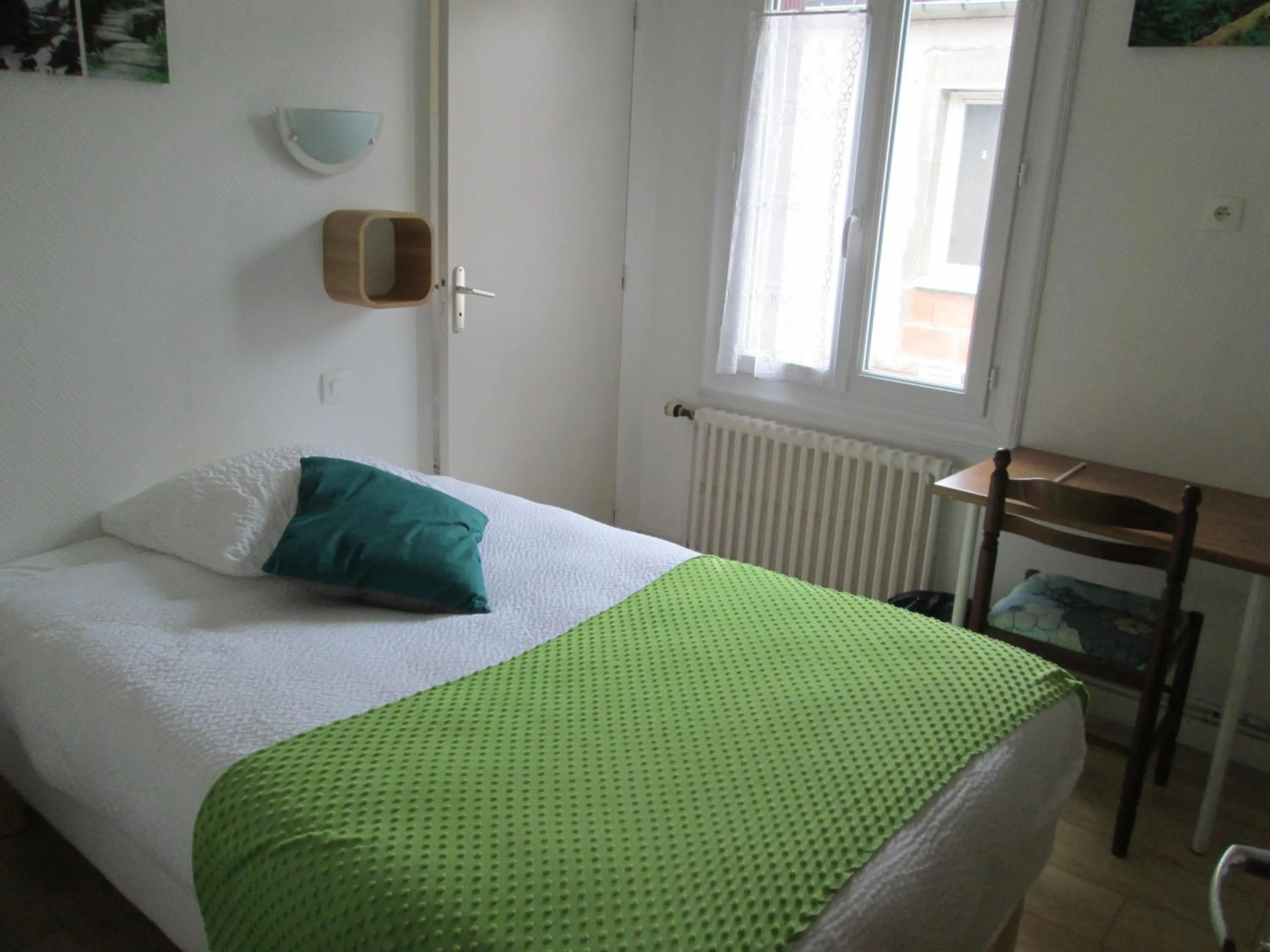 Bed in Logis Hôtel Beauséjour