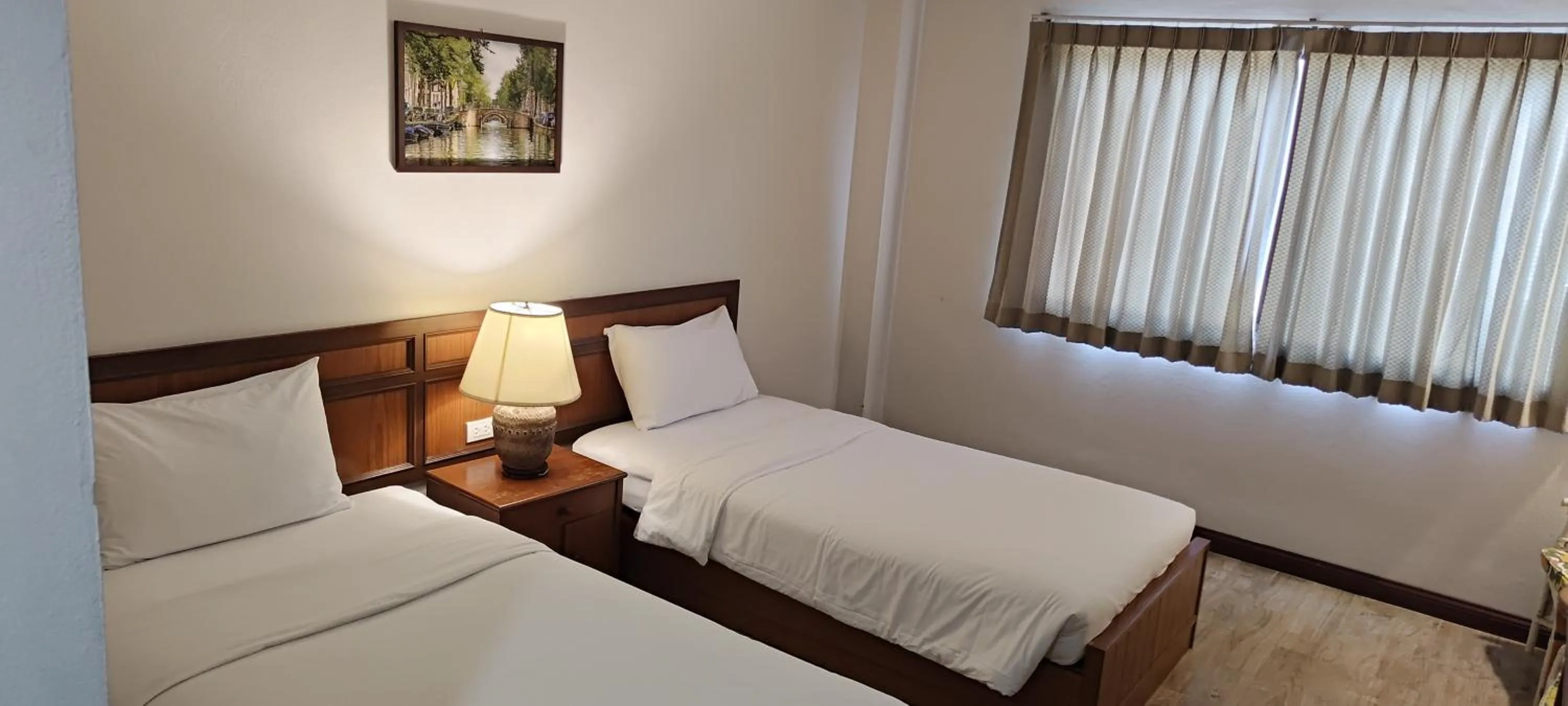 Bed in Puangpen Villa Hotel