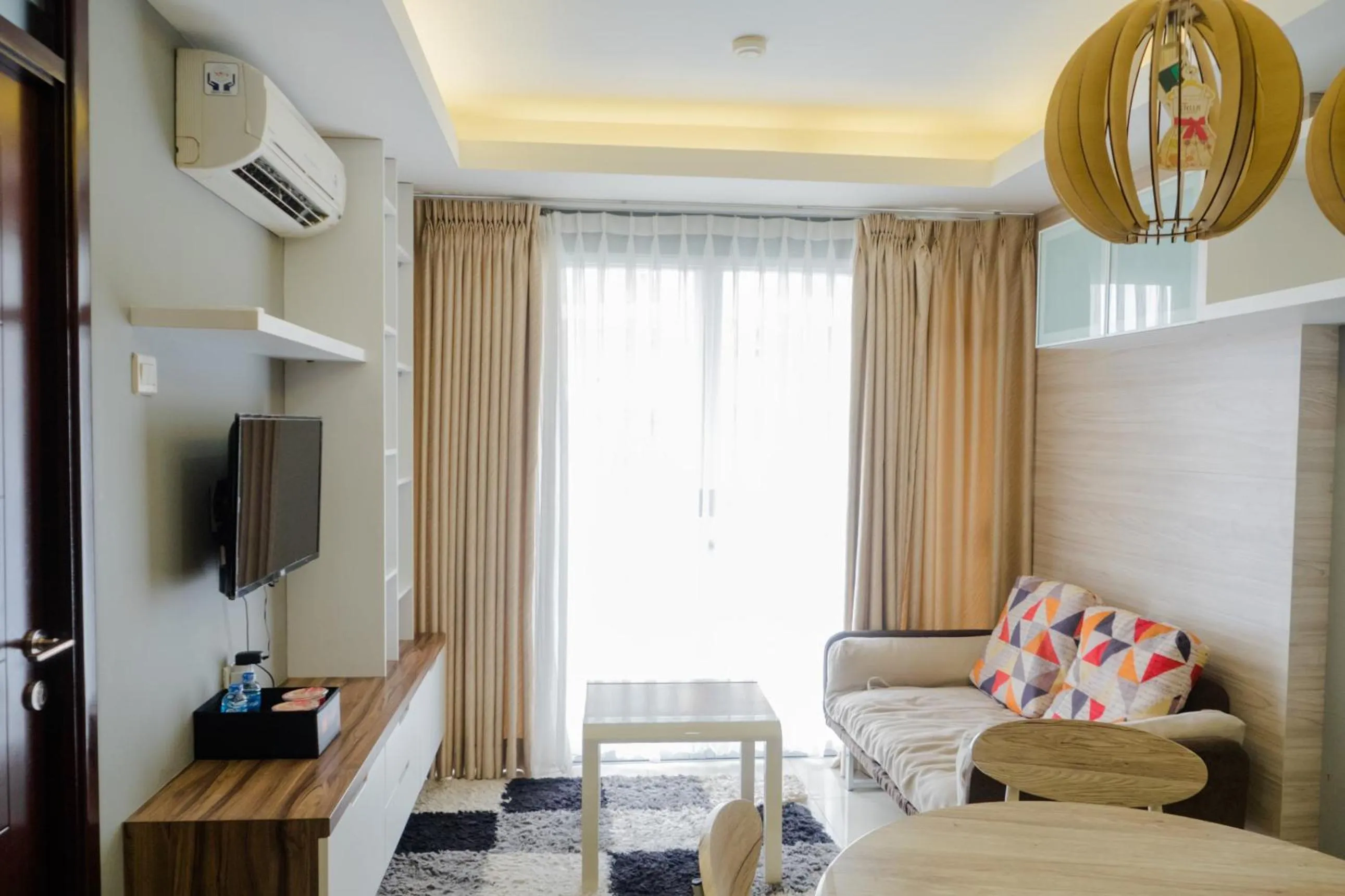 Living room, Bed in Pleasant 2BR Apartment at Gateway Pasteur By Travelio