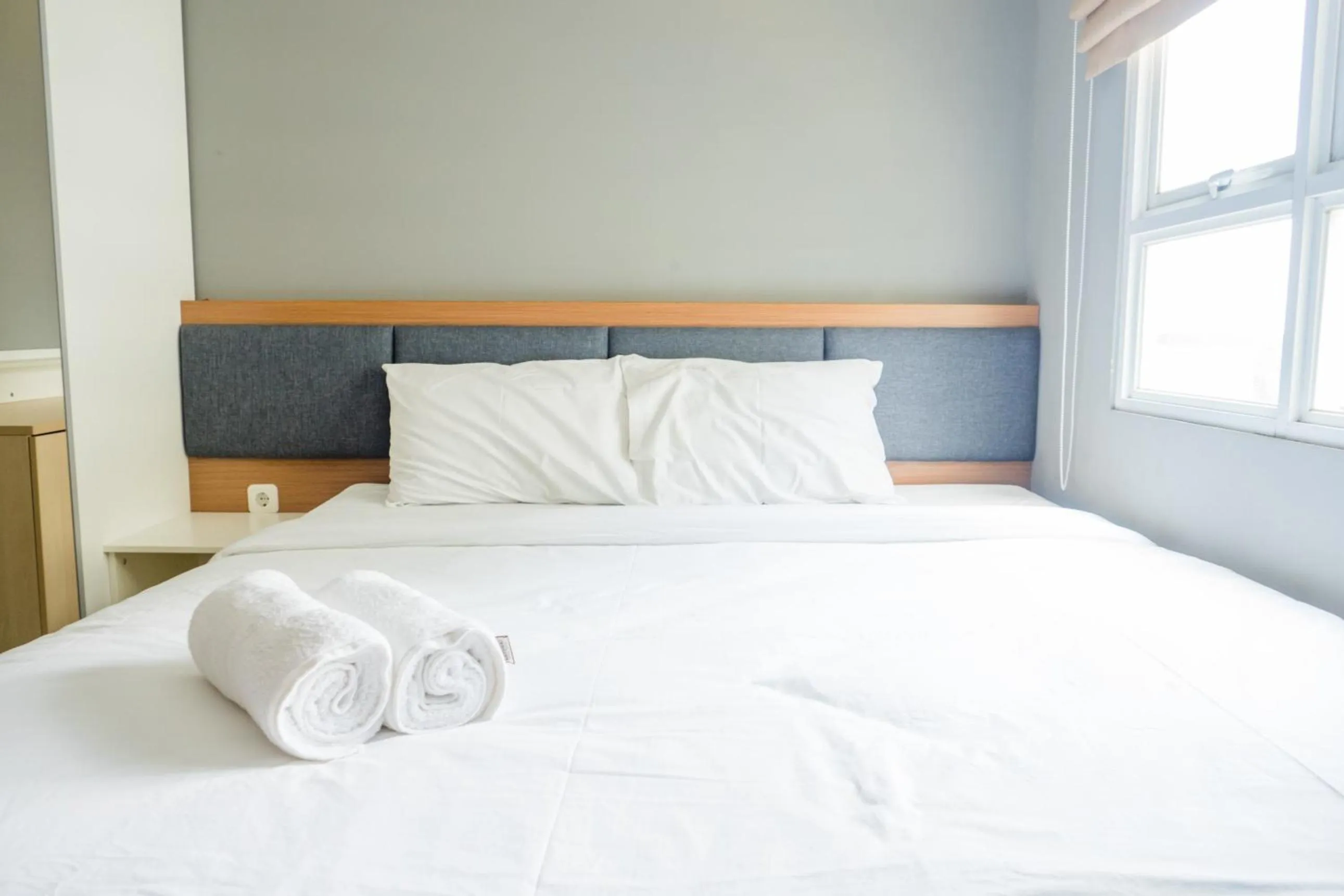 Bed in Pleasant 2BR Apartment at Gateway Pasteur By Travelio