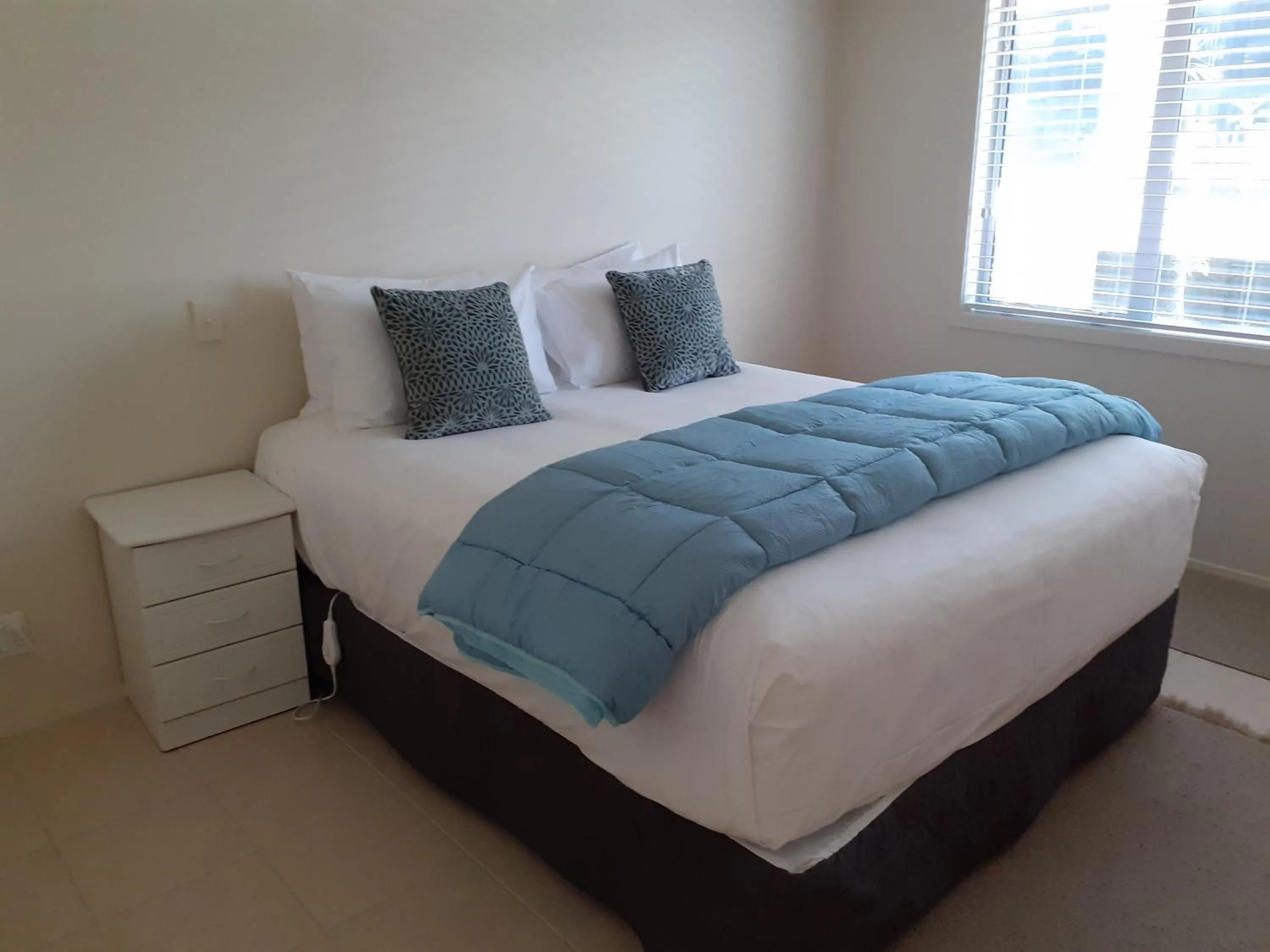 Bed in Pavilion Beachfront Apartments