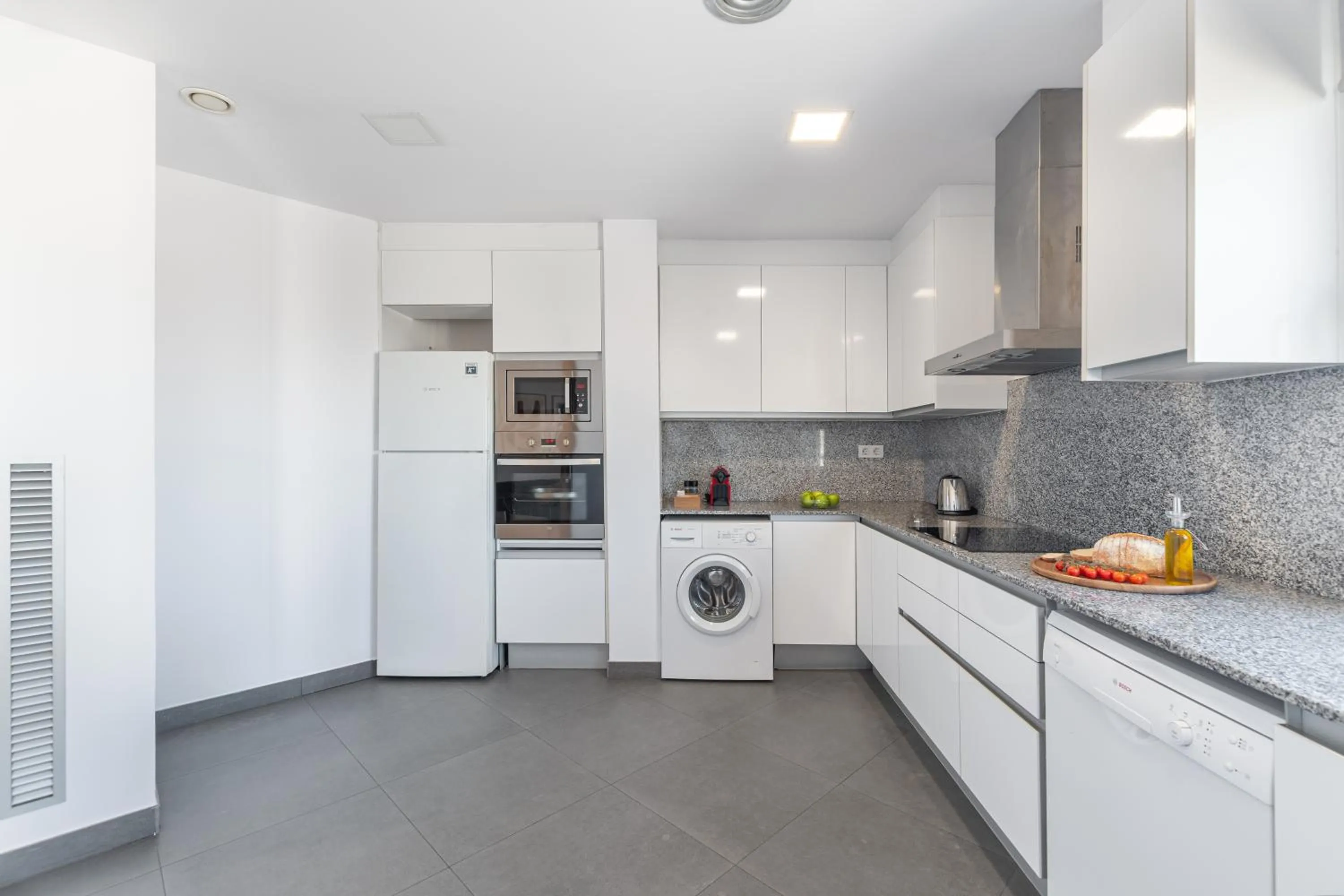 Kitchen or kitchenette in The Corner Apartments by Aspasios