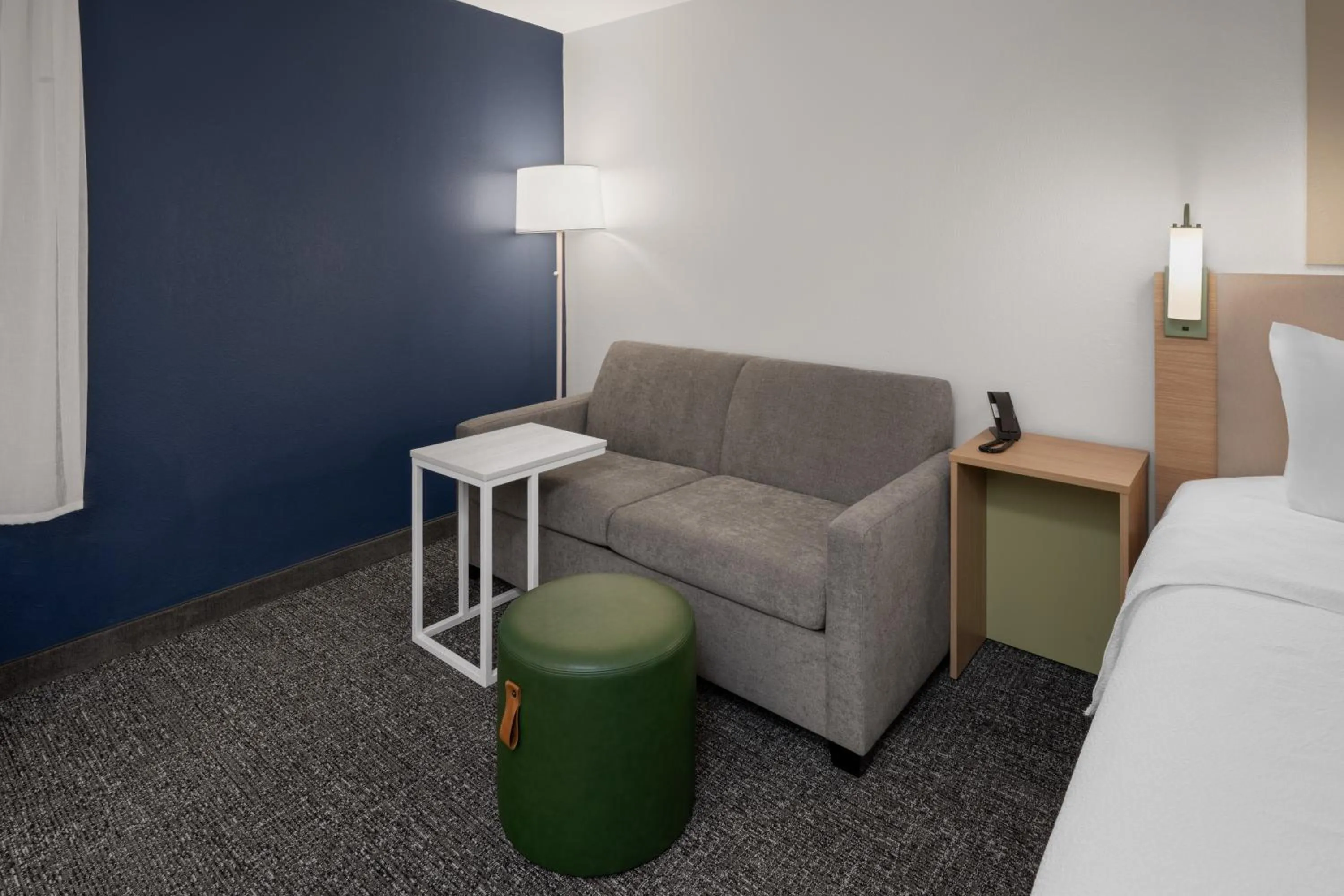 Seating area, Bed in Spark by Hilton Decatur