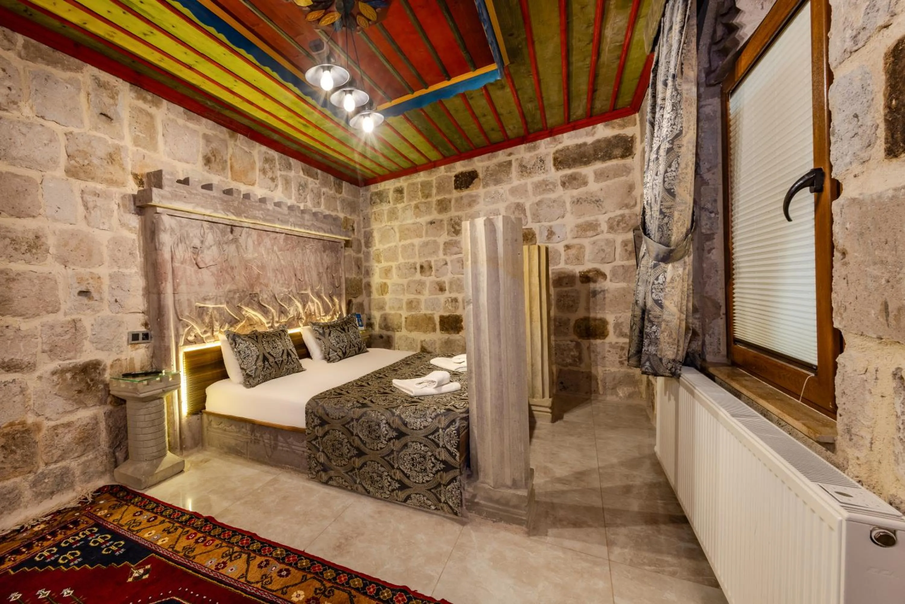 Bed in Kayatas Cave Suites