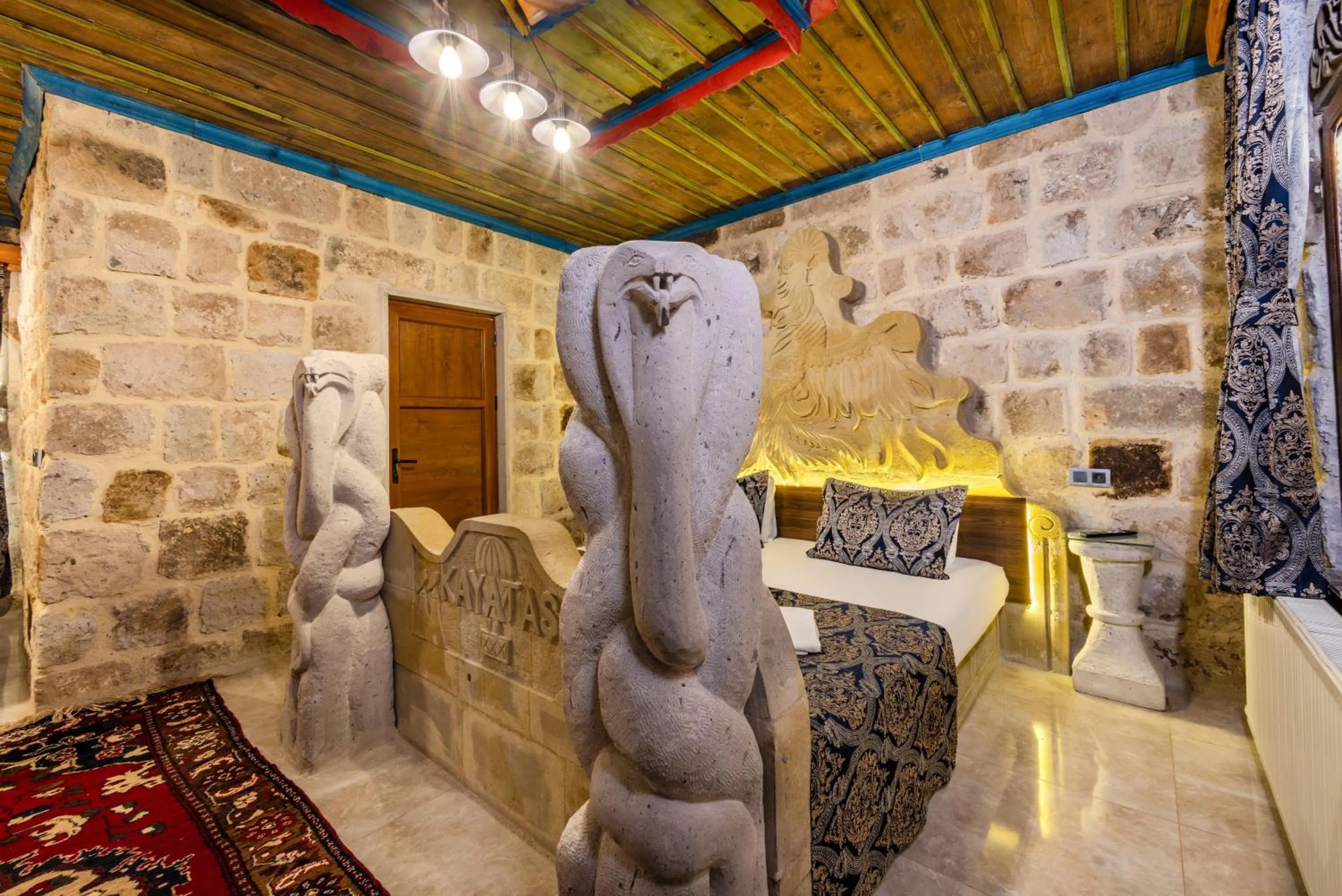 Bed in Kayatas Cave Suites