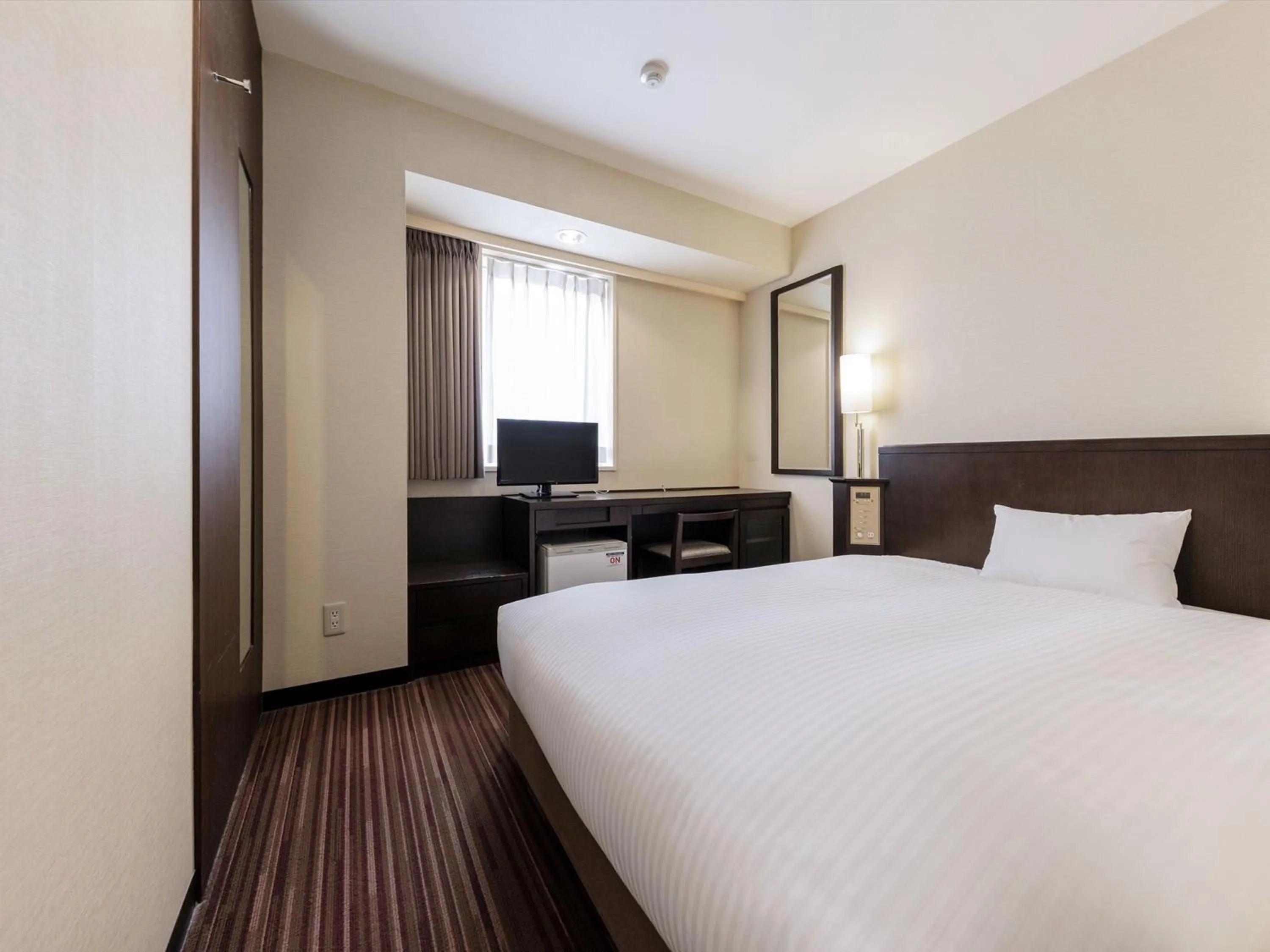 Bed in Nishitetsu Inn Kokura