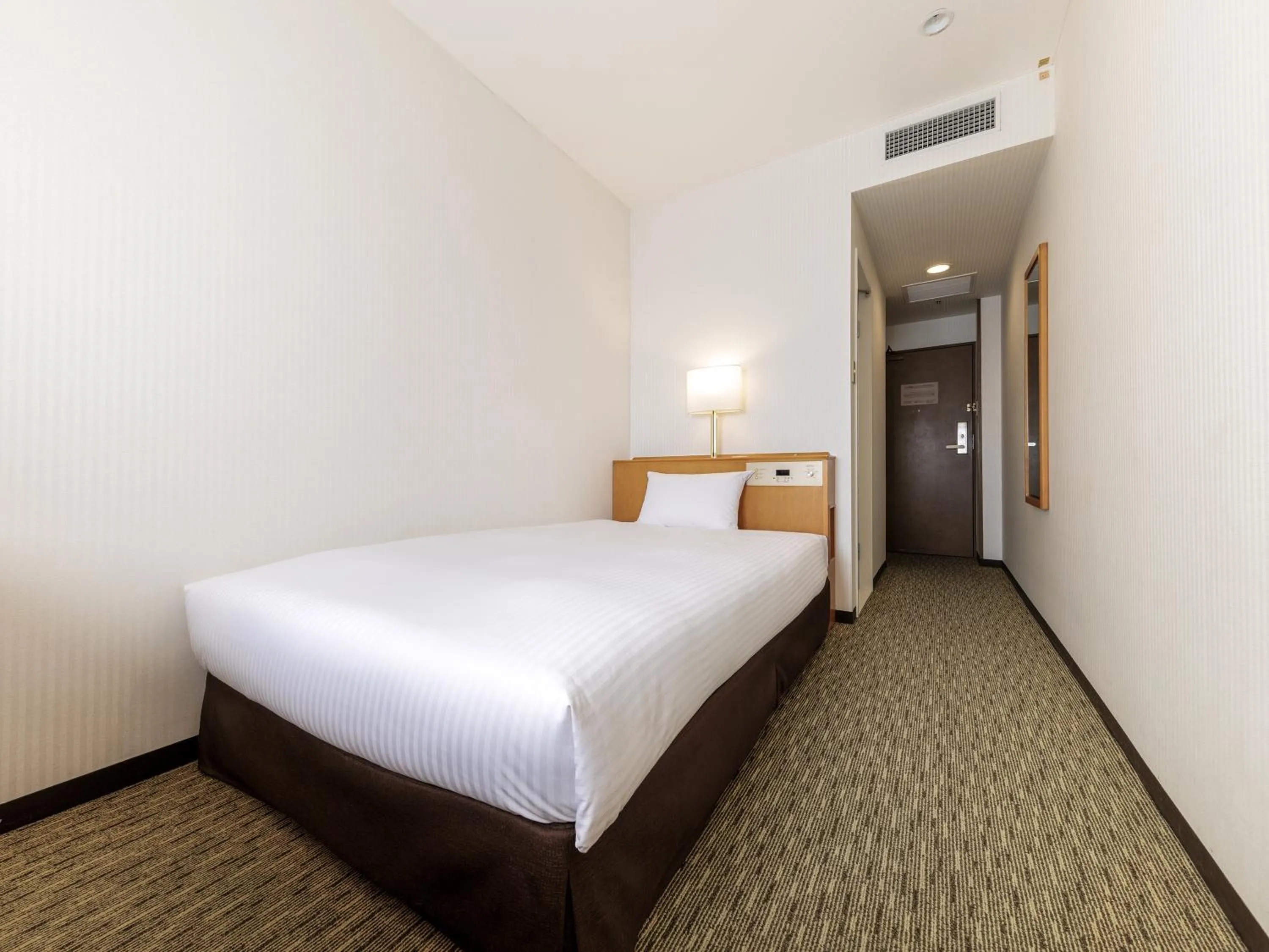 Bed in Nishitetsu Inn Kurosaki