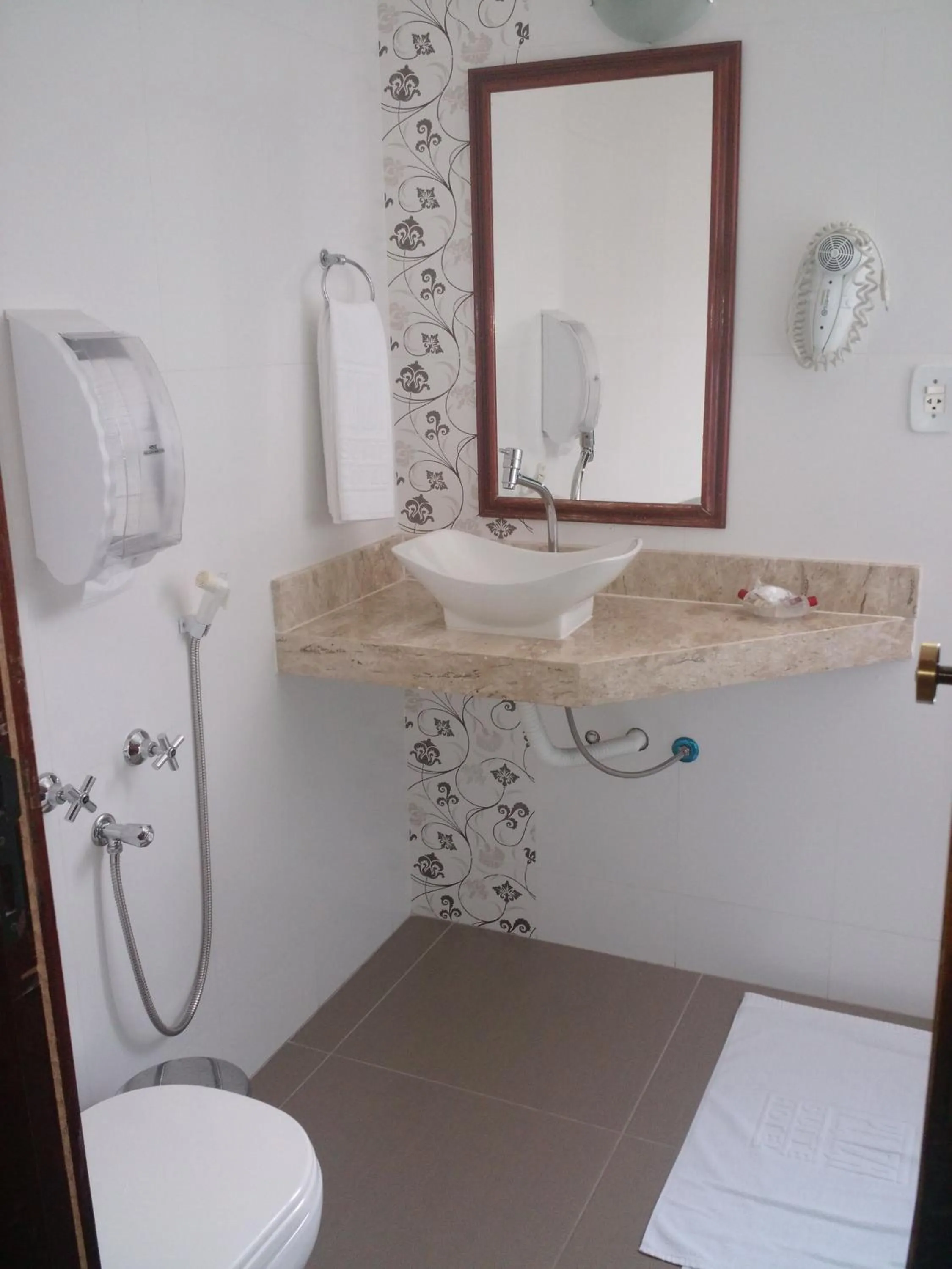 Toilet in Plaza Suite Hotel