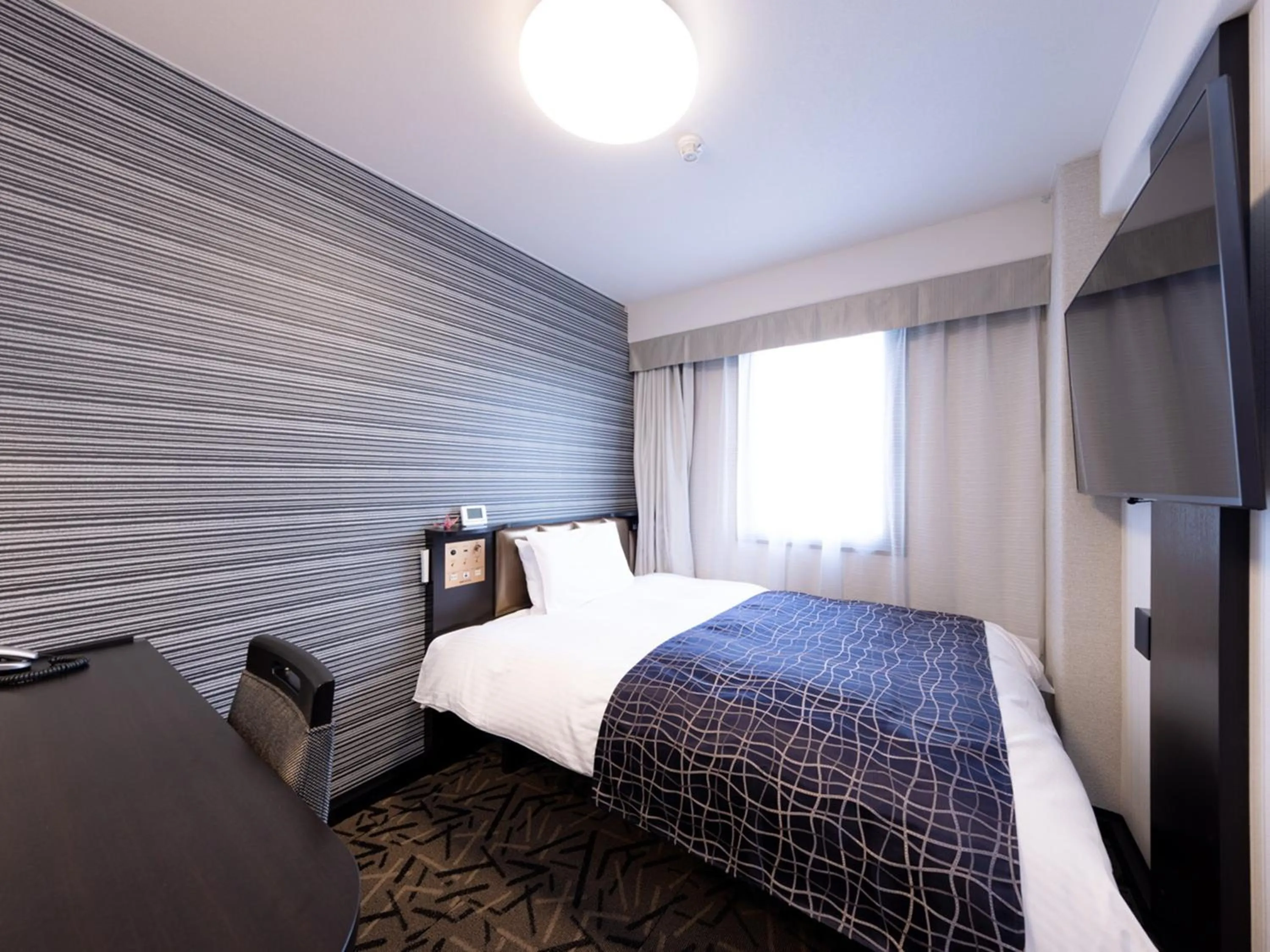 Bed in APA Hotel Miyazaki Eki Tachibanadori