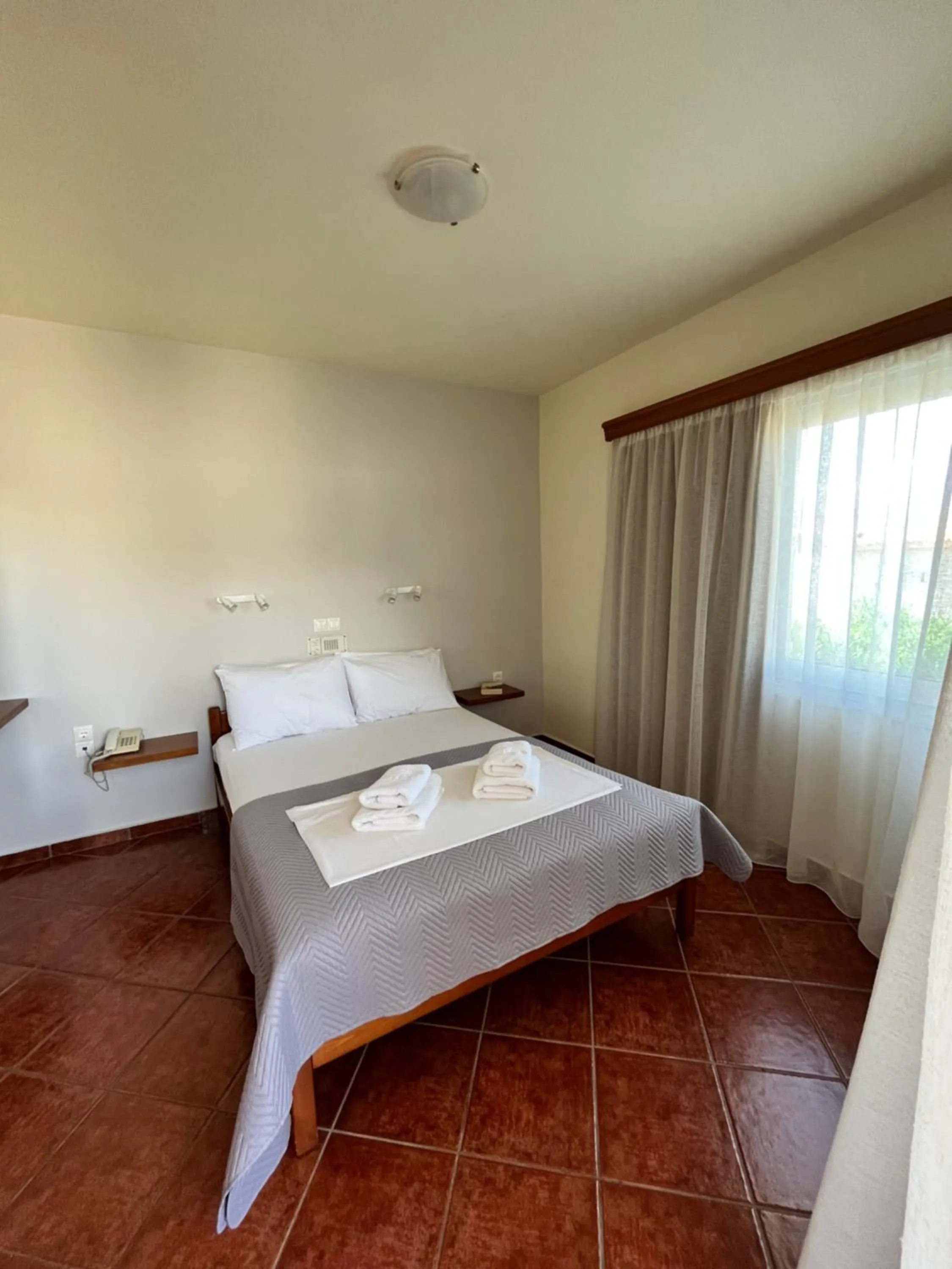 Bed in Iolkos Hotel Apartments