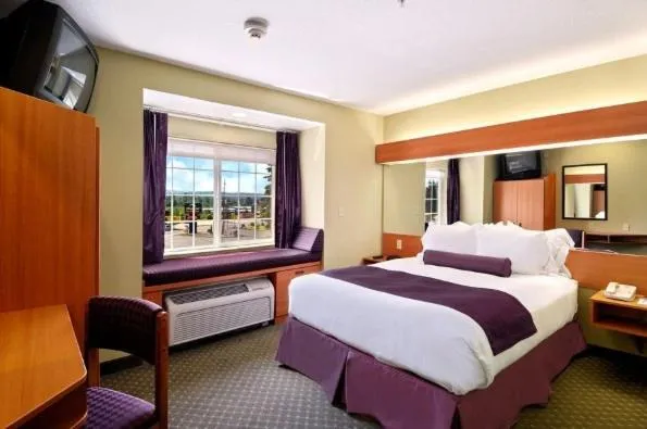 Bed in Stay Beyond Inn & Suites