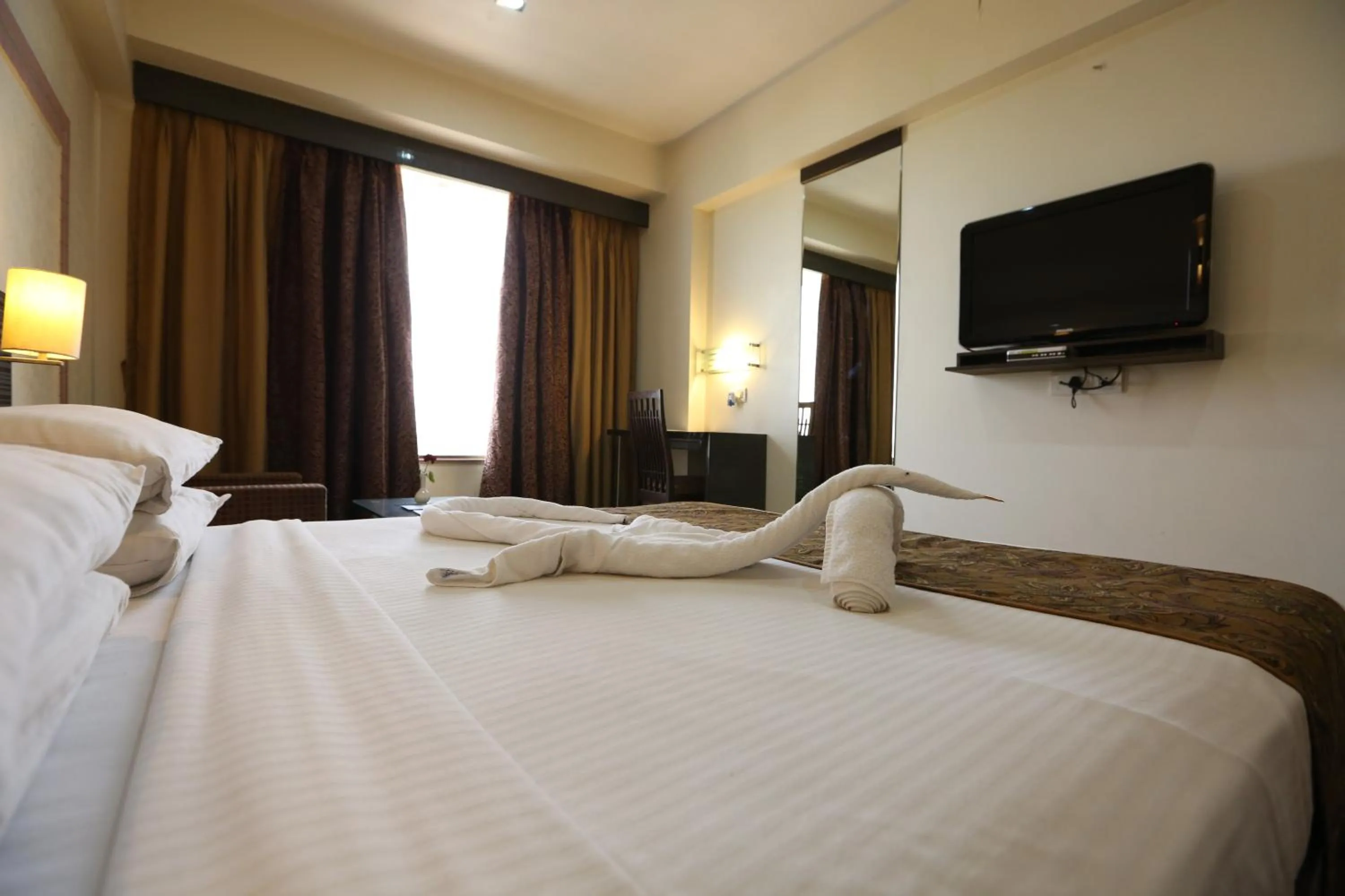 Bed in SilverCloud Hotel and Banquets