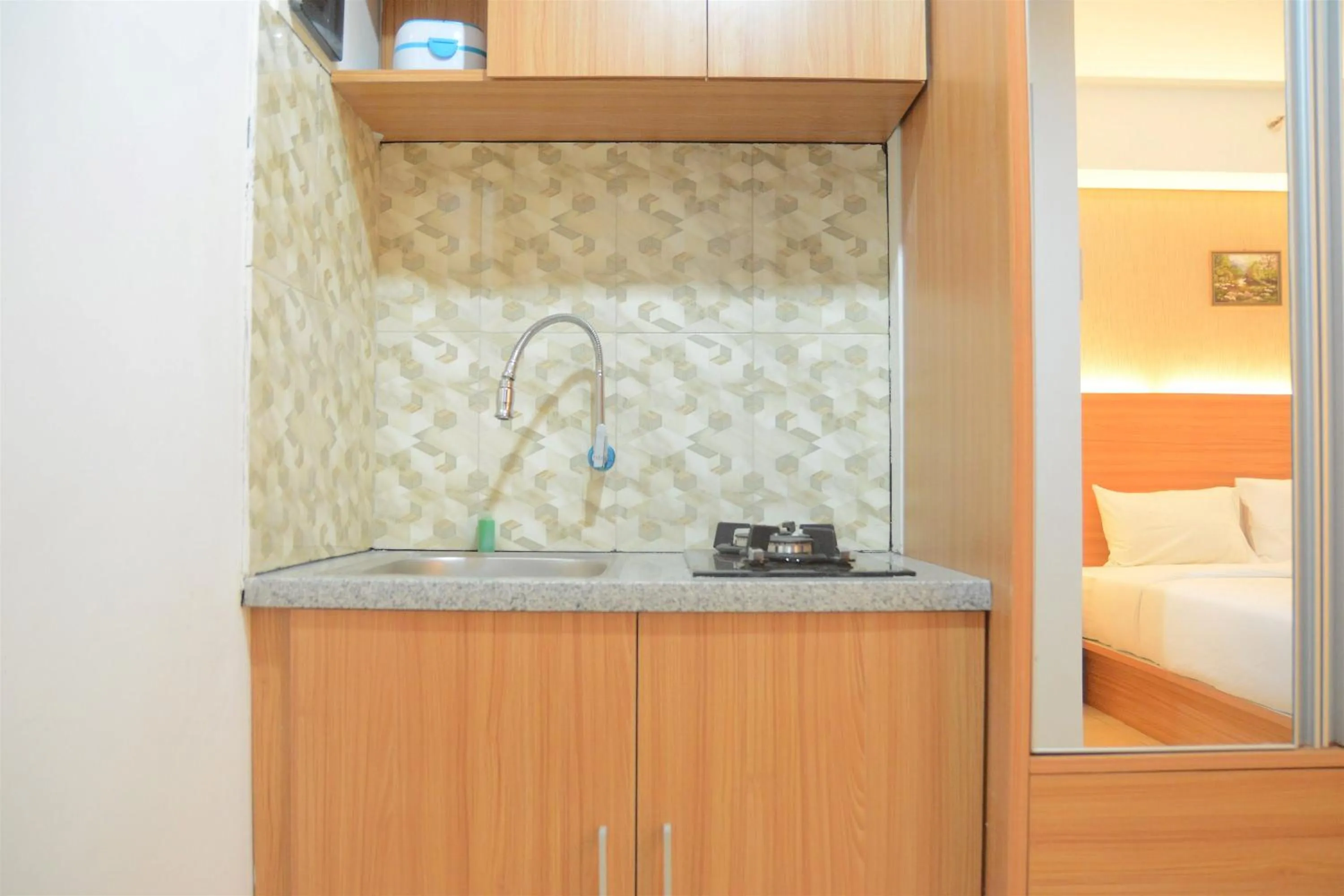 Kitchen or kitchenette in Simply Studio Room at Annora Living Apartment Tangerang By Travelio