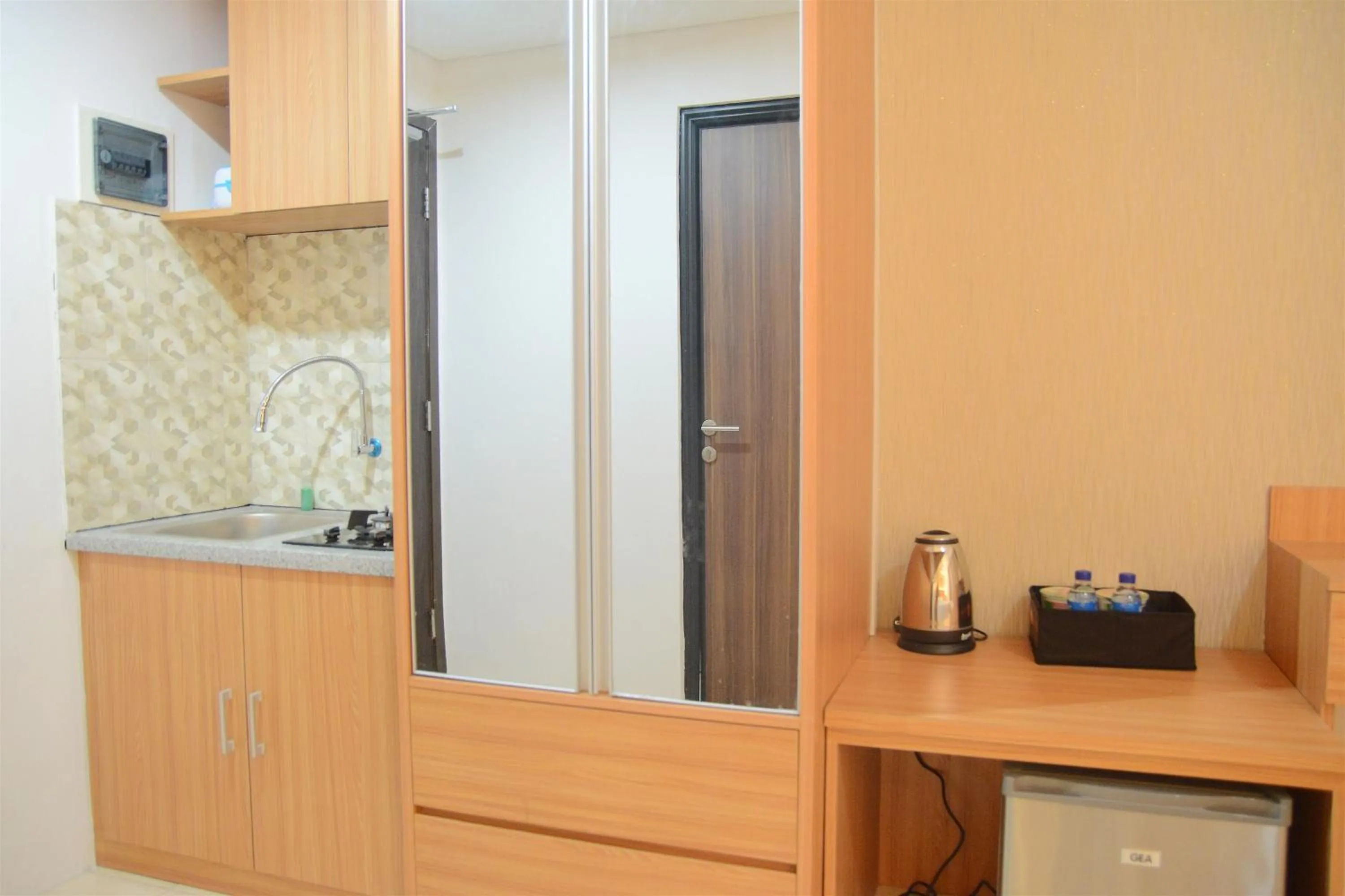 Kitchen or kitchenette in Simply Studio Room at Annora Living Apartment Tangerang By Travelio