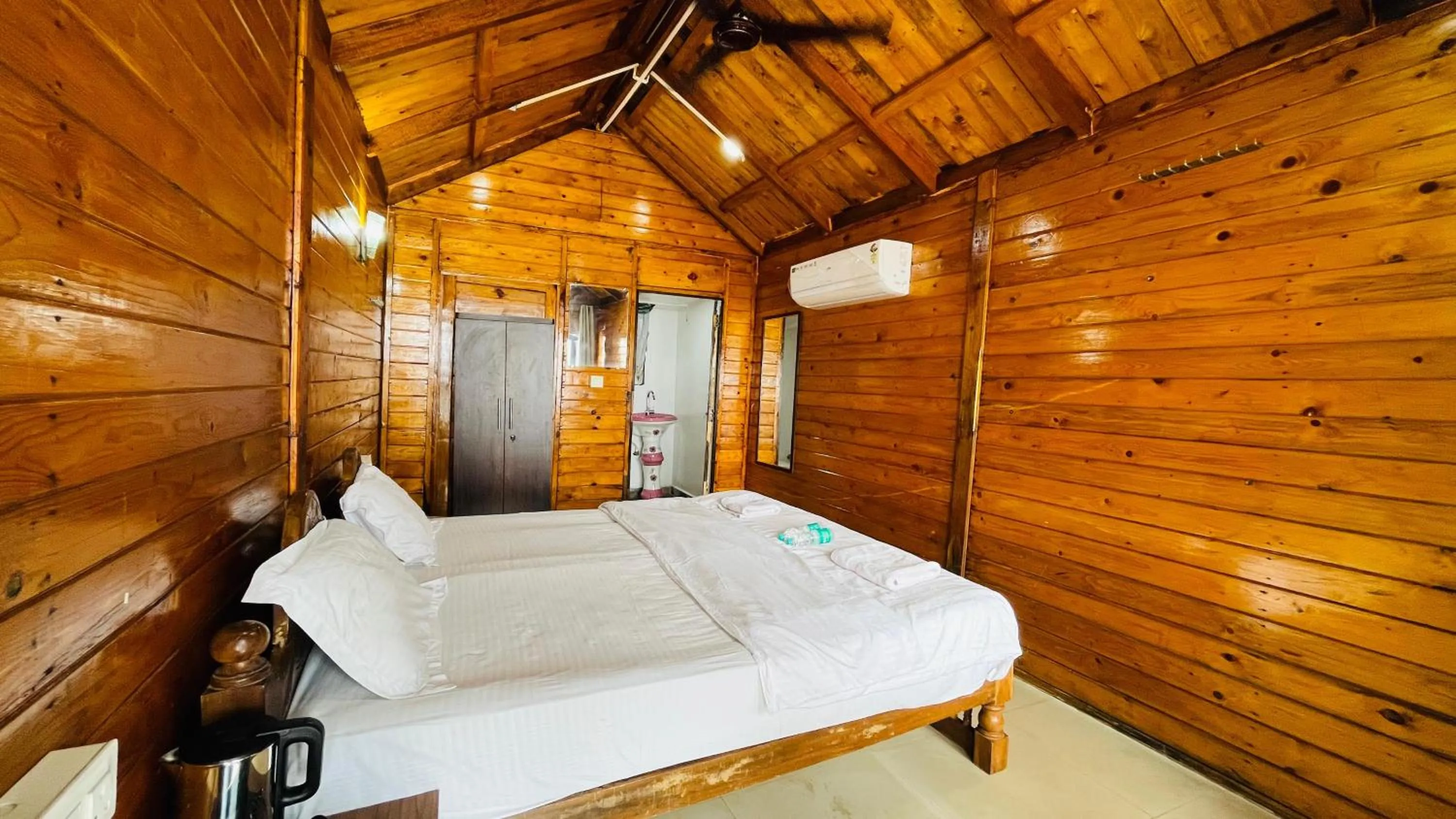 Bed in Palolem Luxuries Beach Cottages