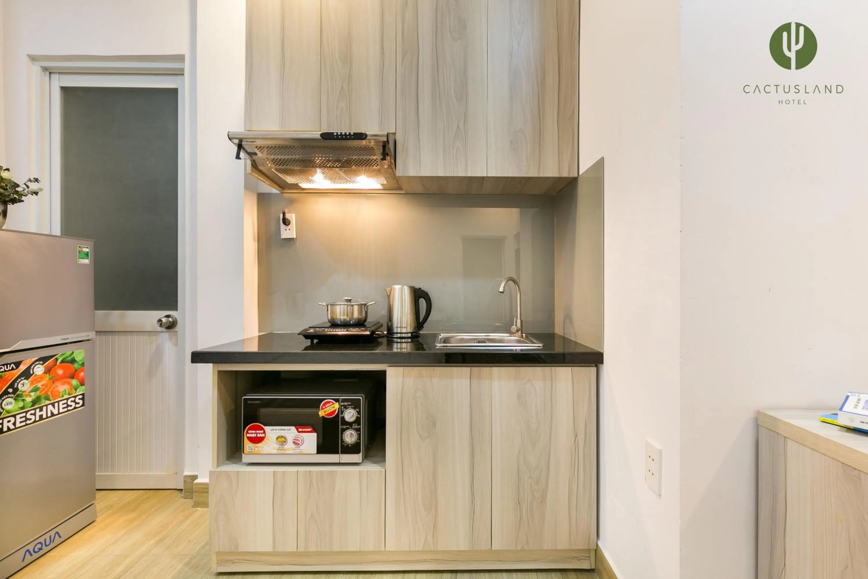 Kitchen or kitchenette in Cactusland Hotel & Apartment