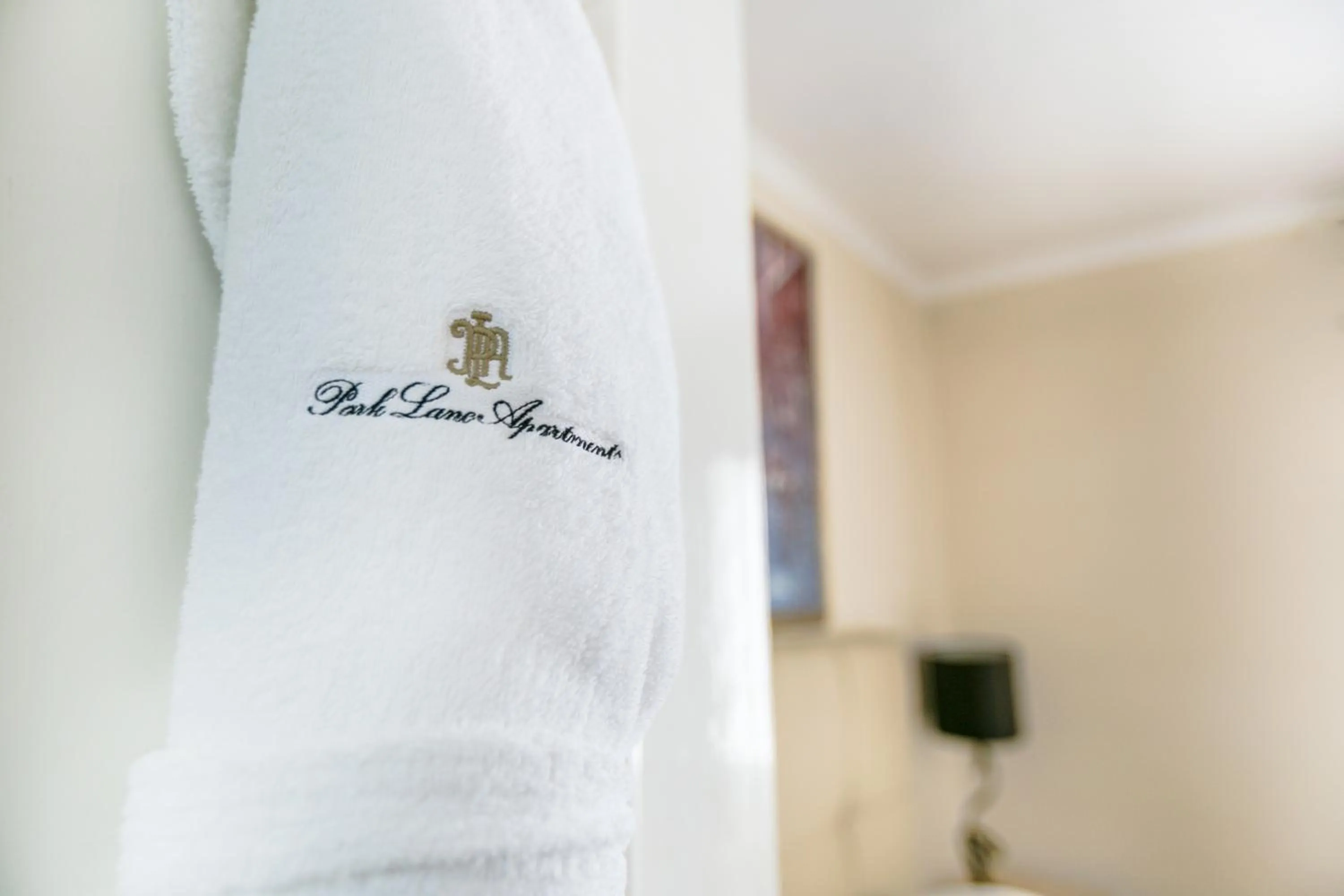 Property logo or sign in Park Lane Apartments/Shaw House