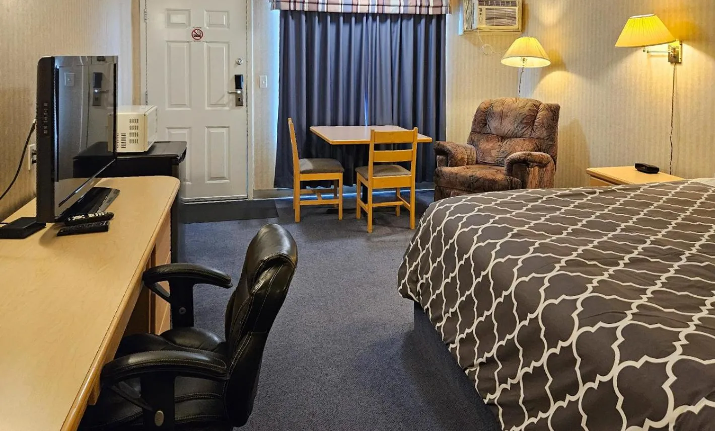 Bed in Perfect Inns & Suites