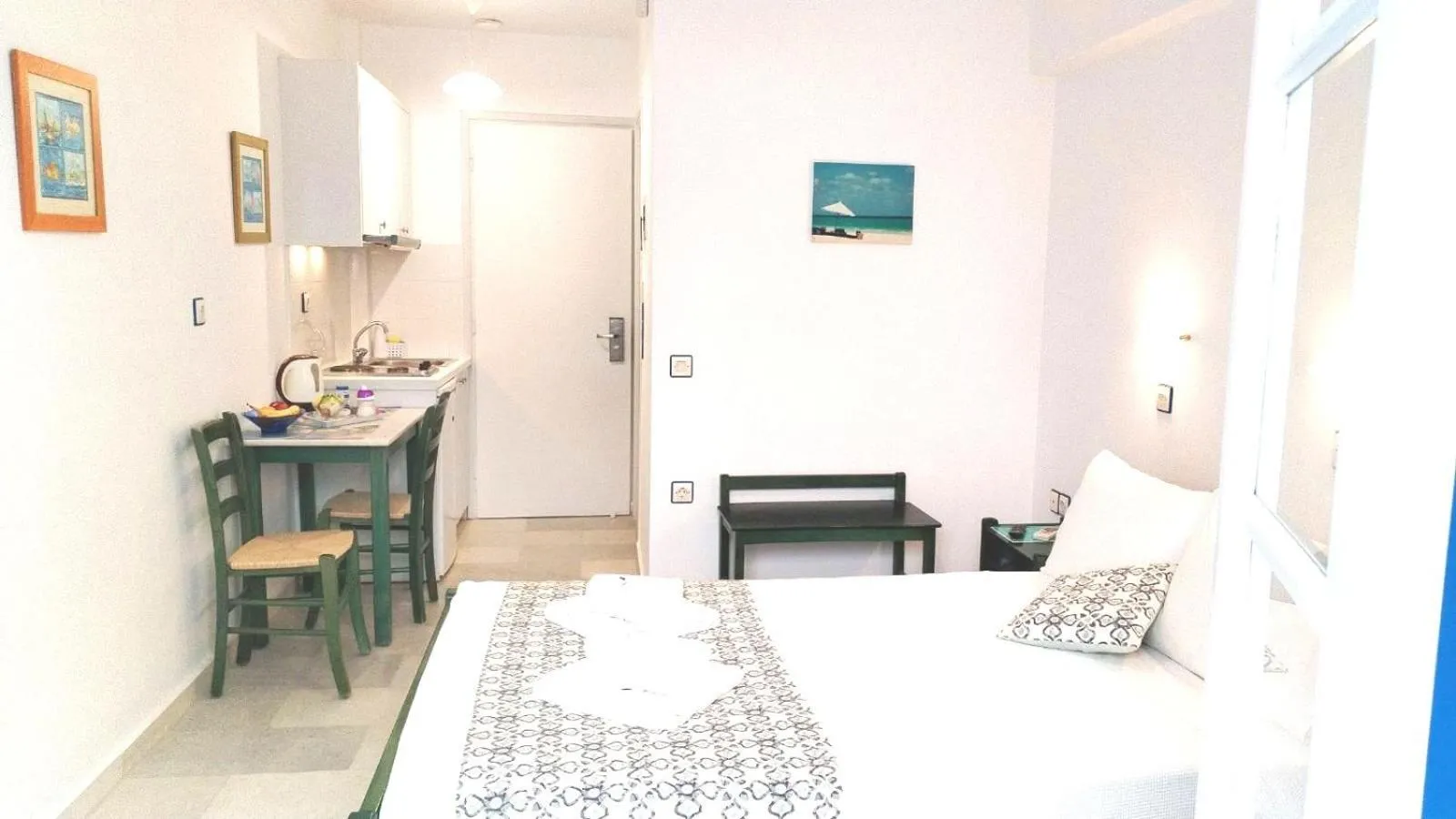 Kitchen or kitchenette, Bed in Nostos Studios at Saint George beach Agios Georgios Chora Naxos town