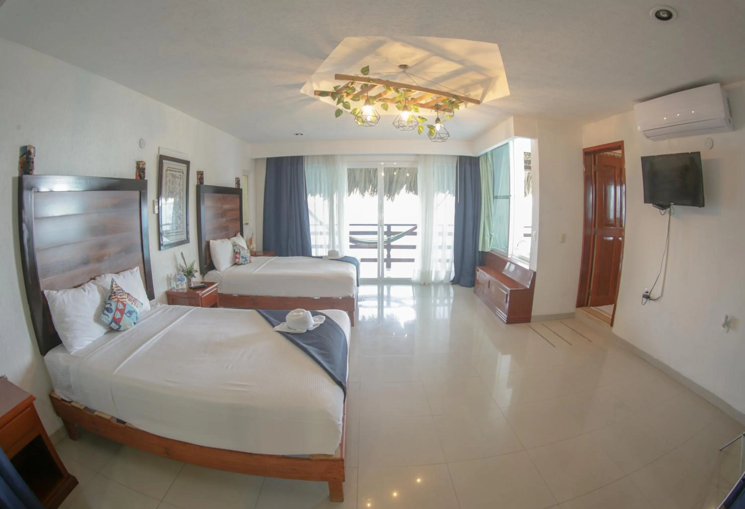 Communal lounge/ TV room, Bed in Seven Blue House Village & Lodge