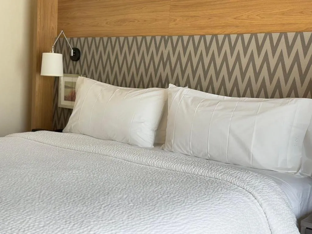 Photo of the whole room, Bed in Holiday Inn & Suites - Fayetteville W-Fort Bragg Area by IHG