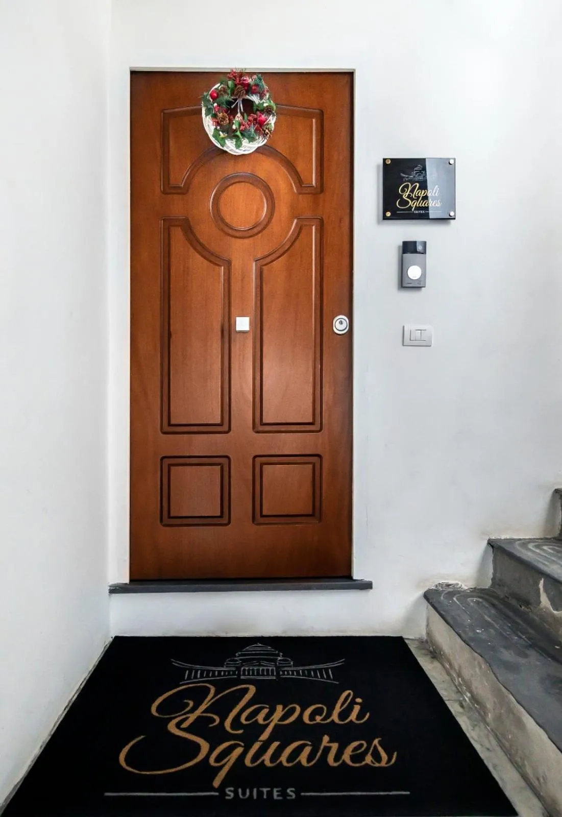 Property logo or sign in Napoli Squares Suites