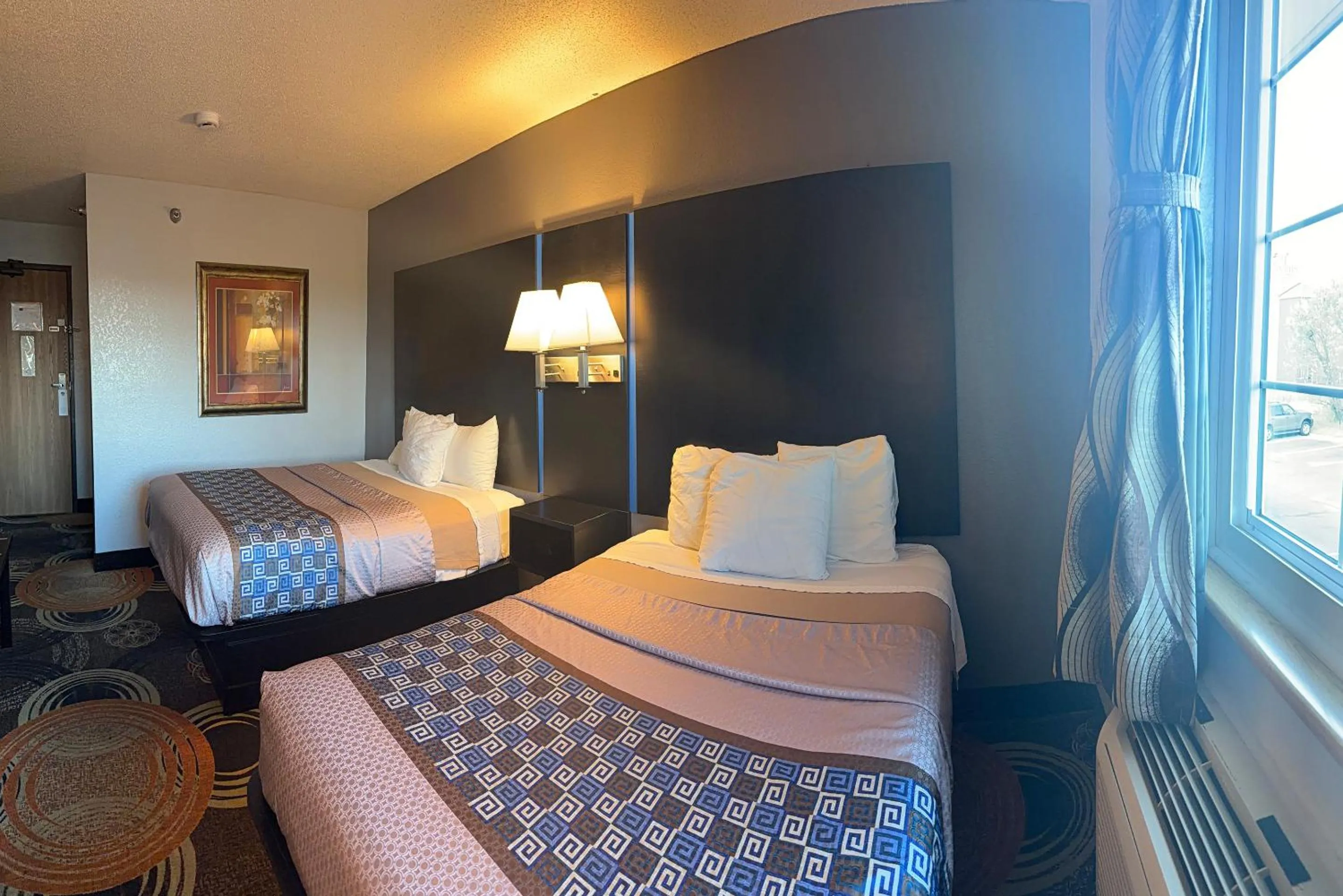 Bed in Coratel Inn and Suites by Jasper Stillwater