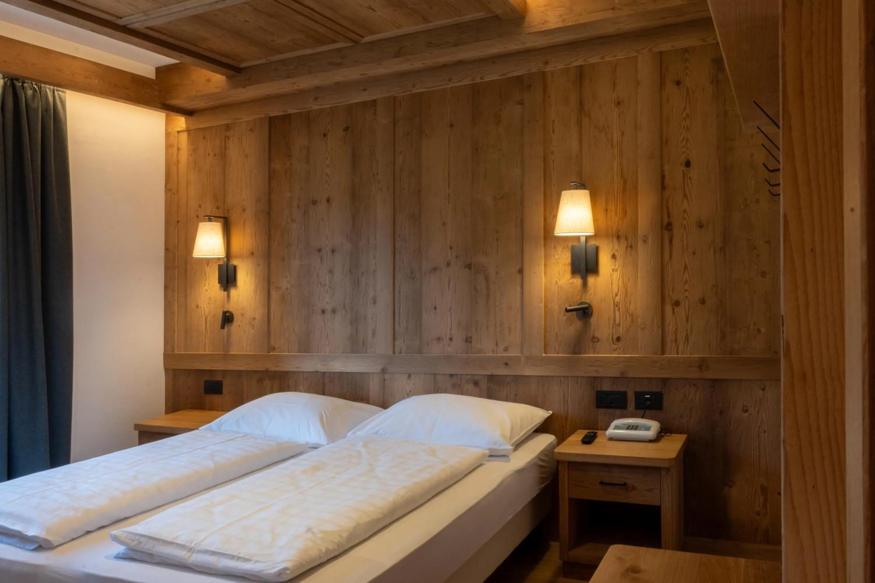 Bed in Belvedere Dolomites Flower Hotel