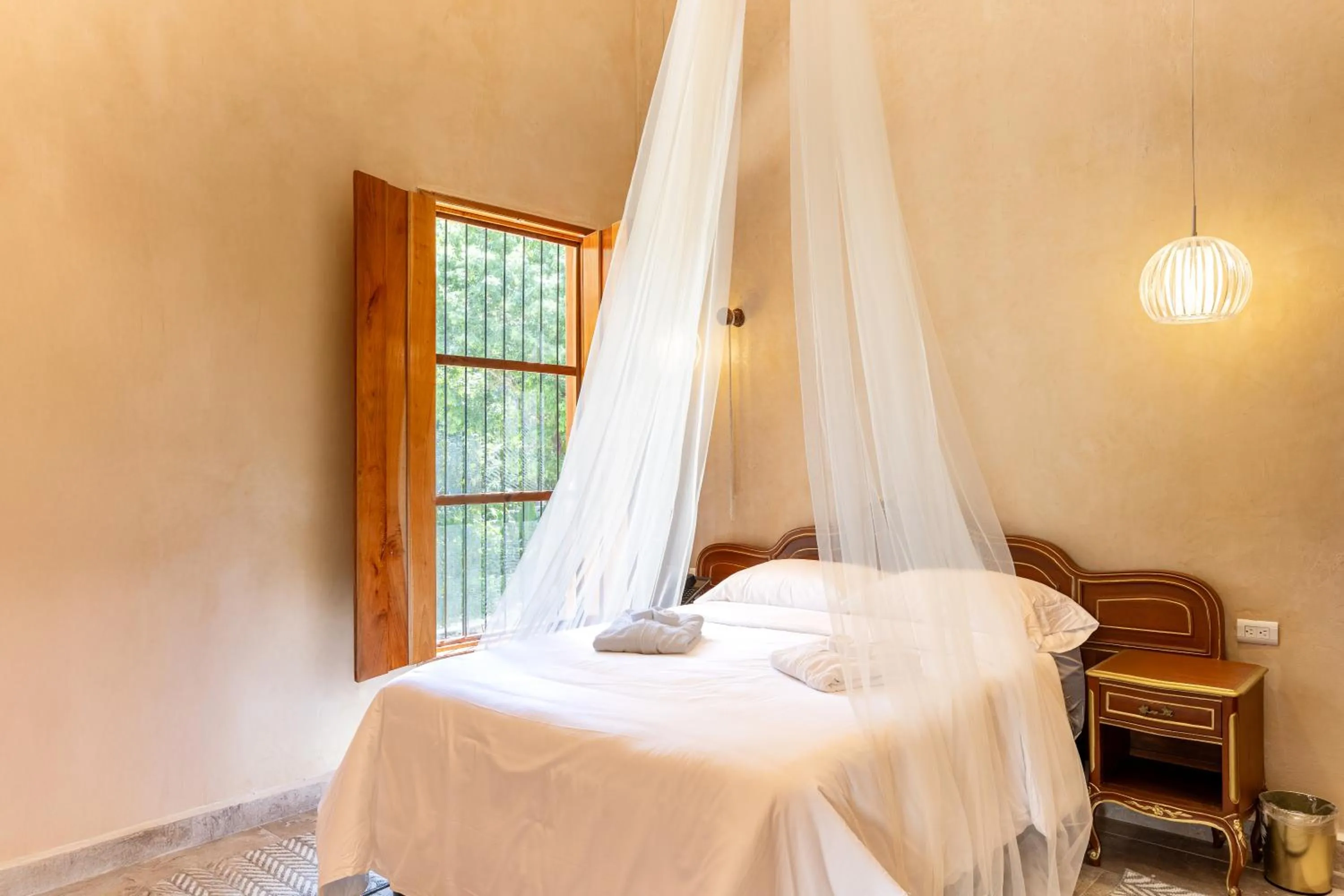 Bed in Hacienda Cenote San Ignacio