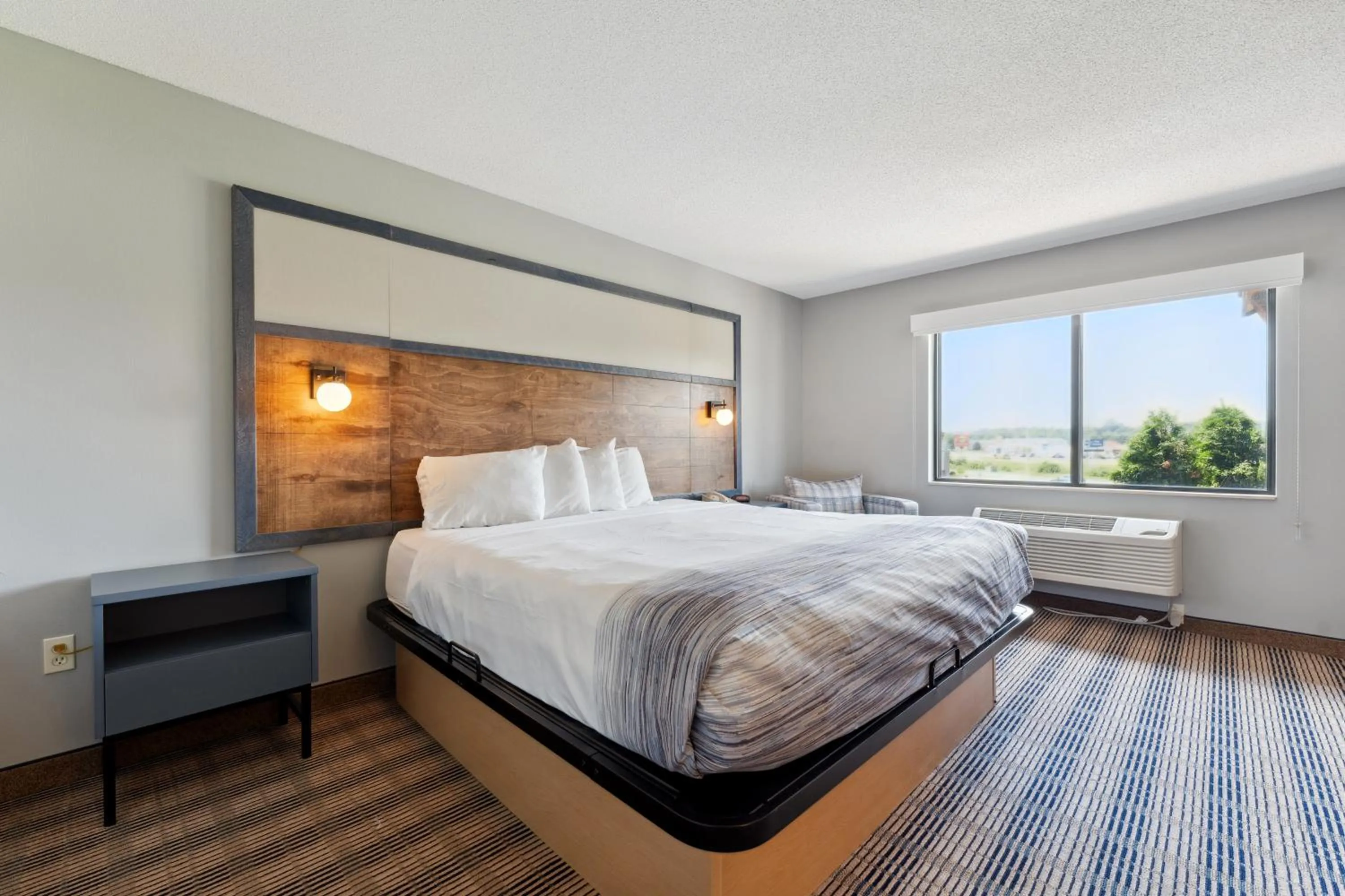 Bed in AmericInn by Wyndham Wisconsin Dells