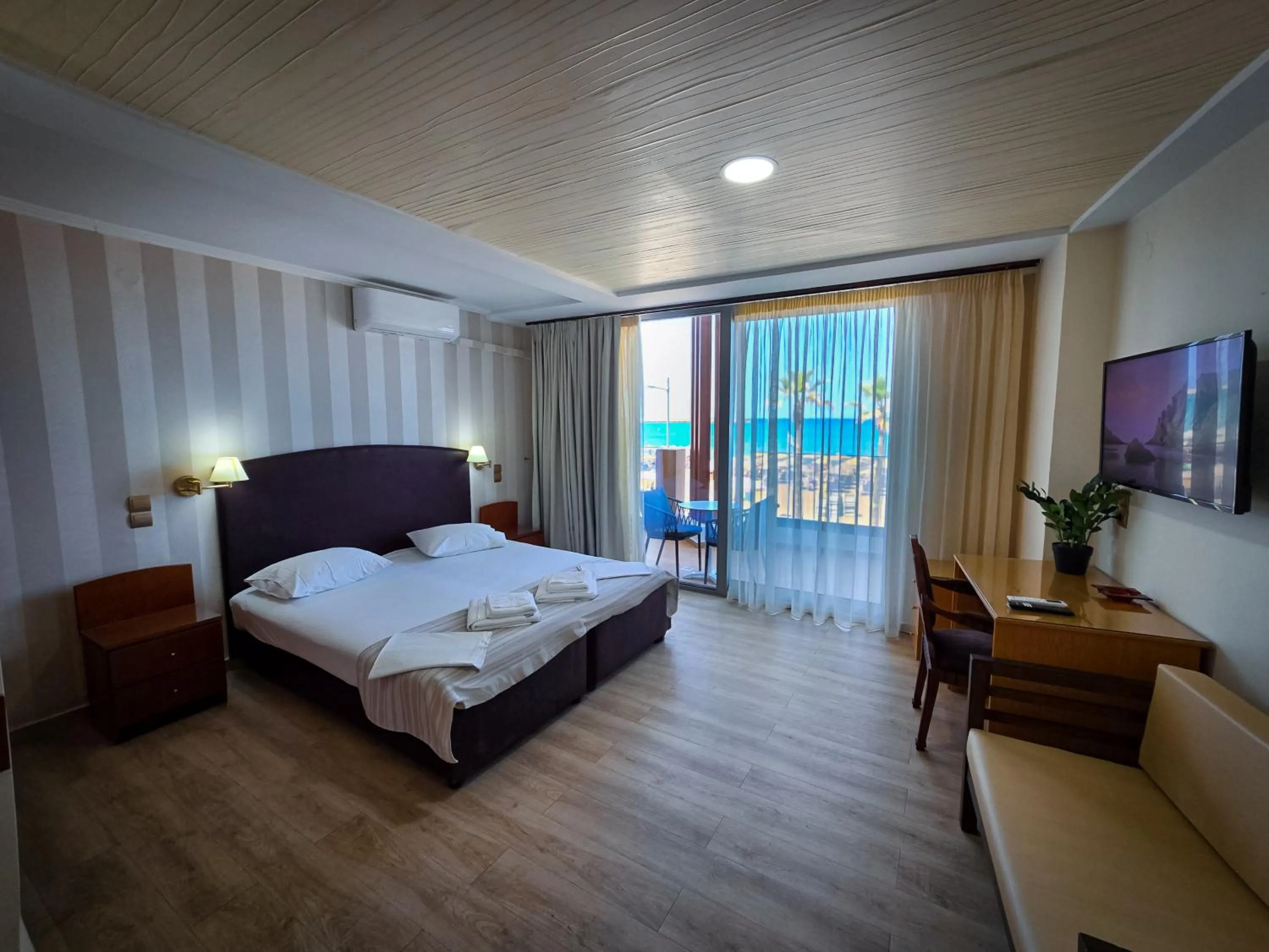 Bed in Theo Beach Hotel Apartments