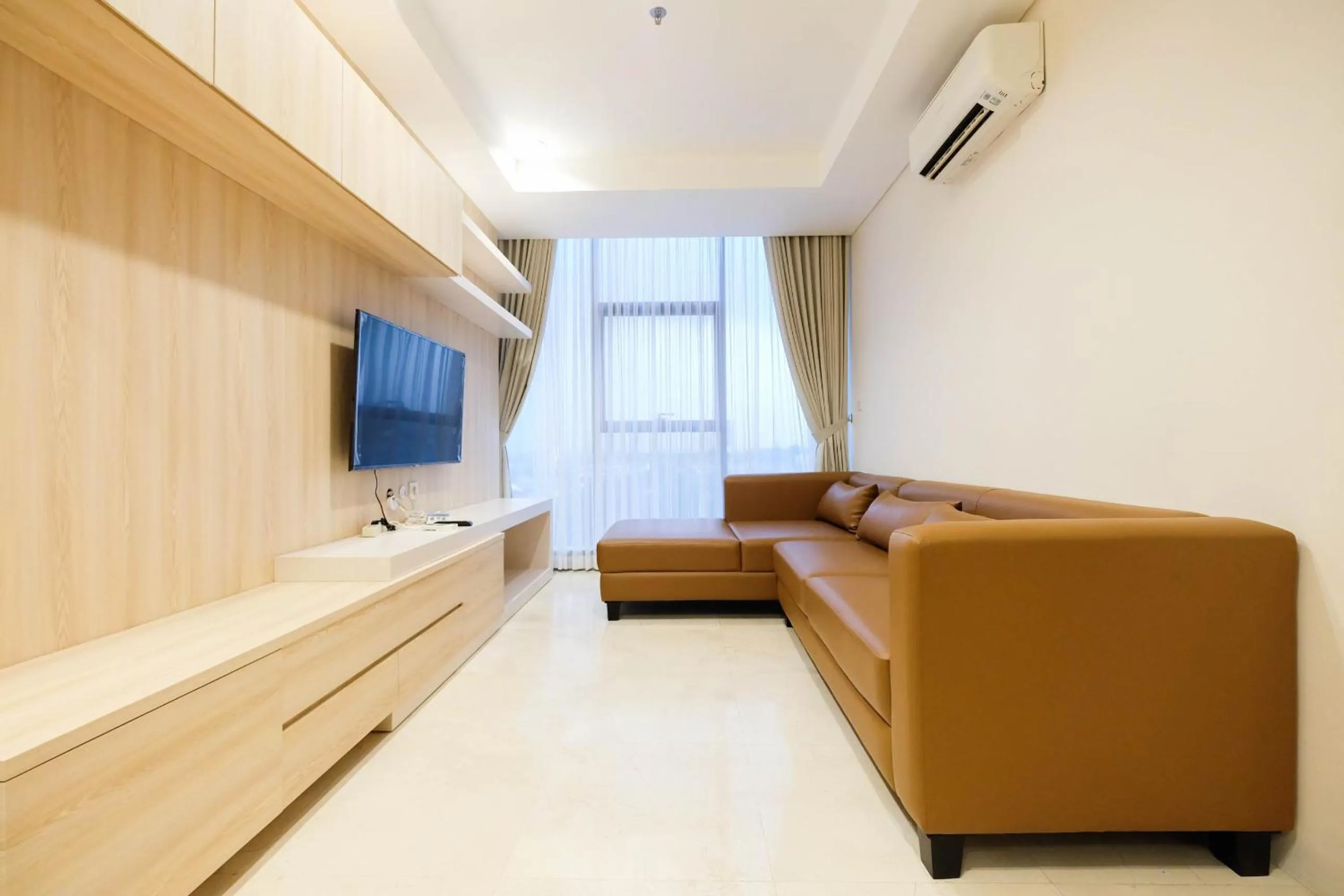 Living room in 2BR Cozy and Modern L'Avenue Apartment By Travelio