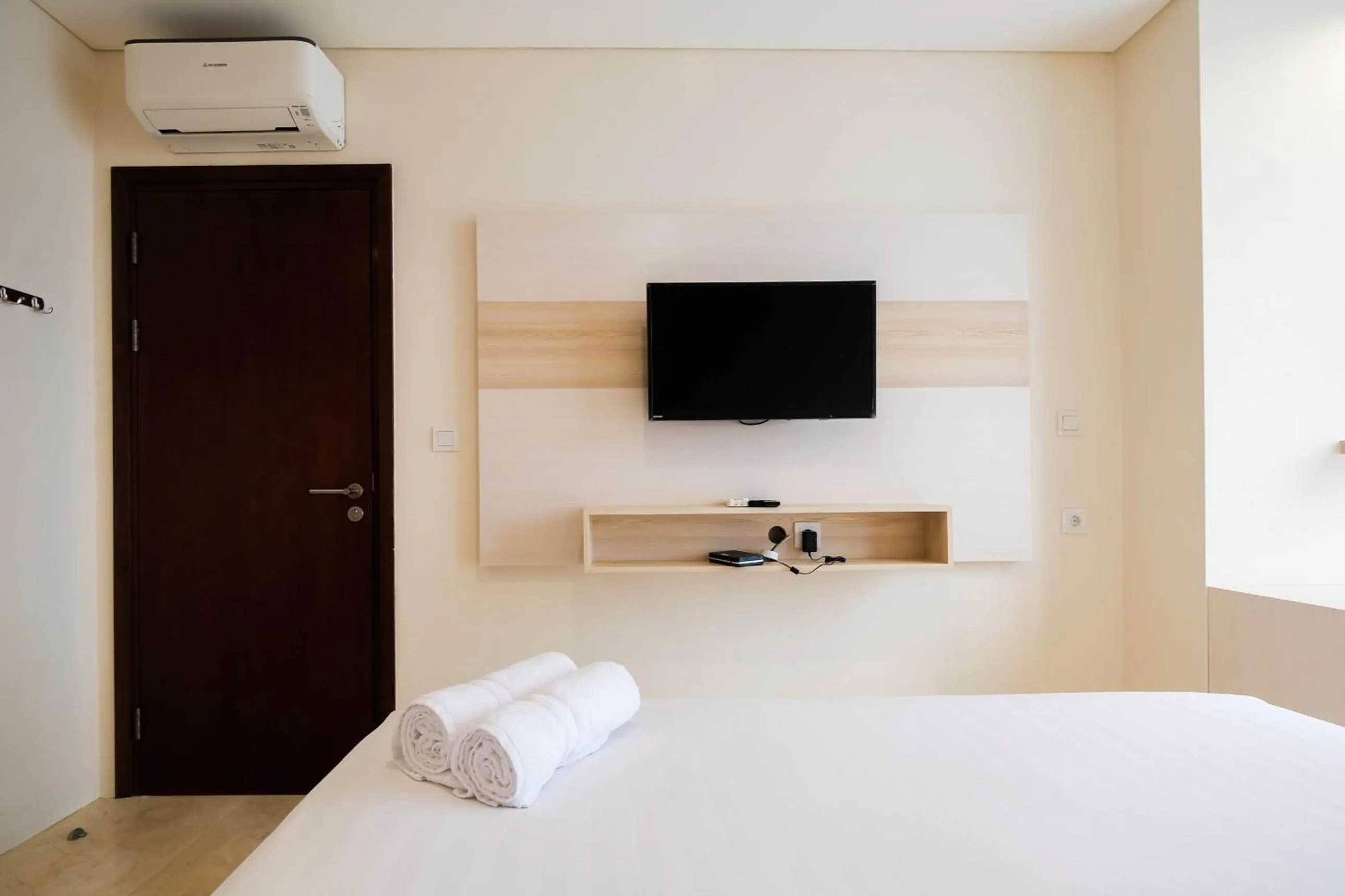 Bed in 2BR Cozy and Modern L'Avenue Apartment By Travelio