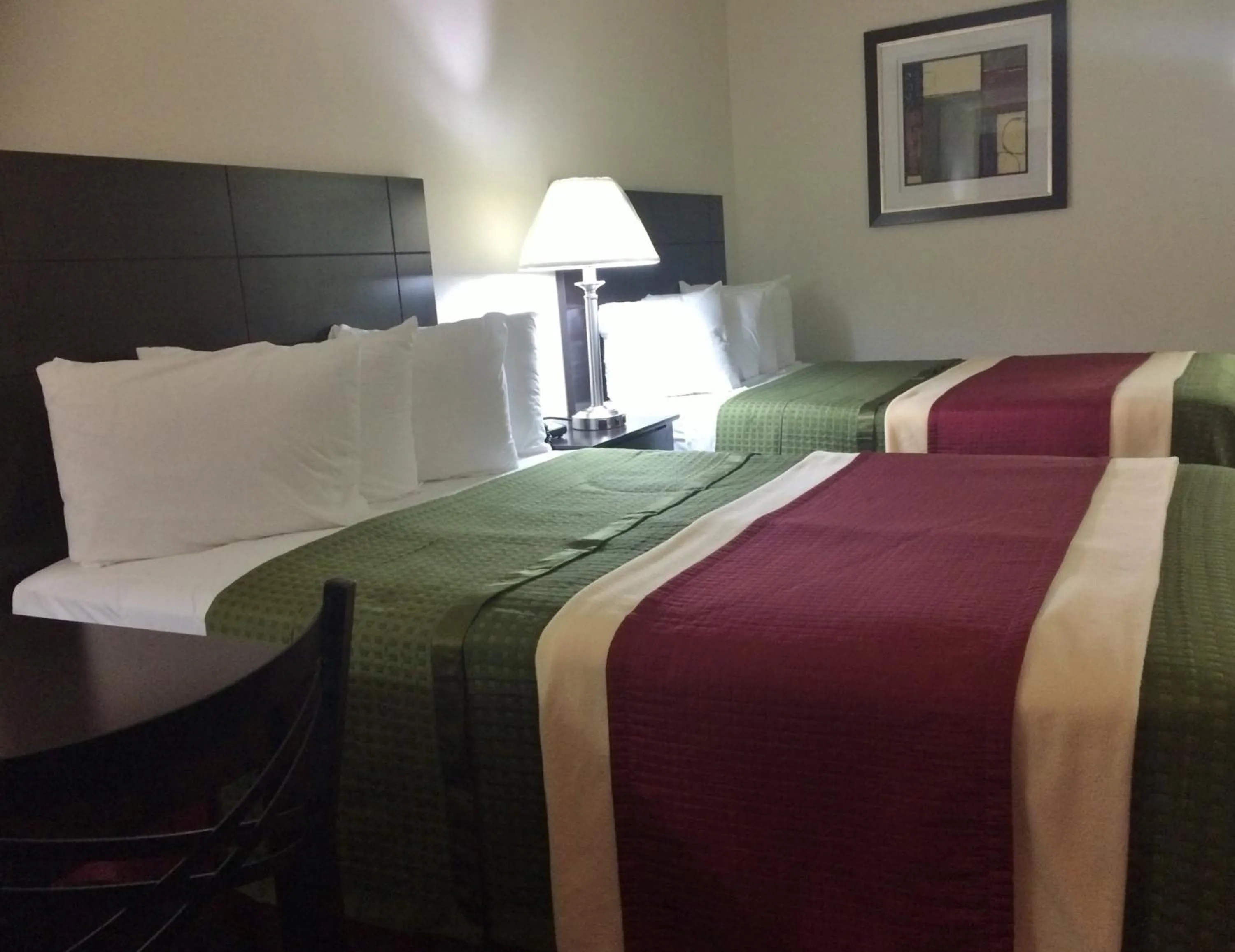 Bed in Travel Inn & Suites