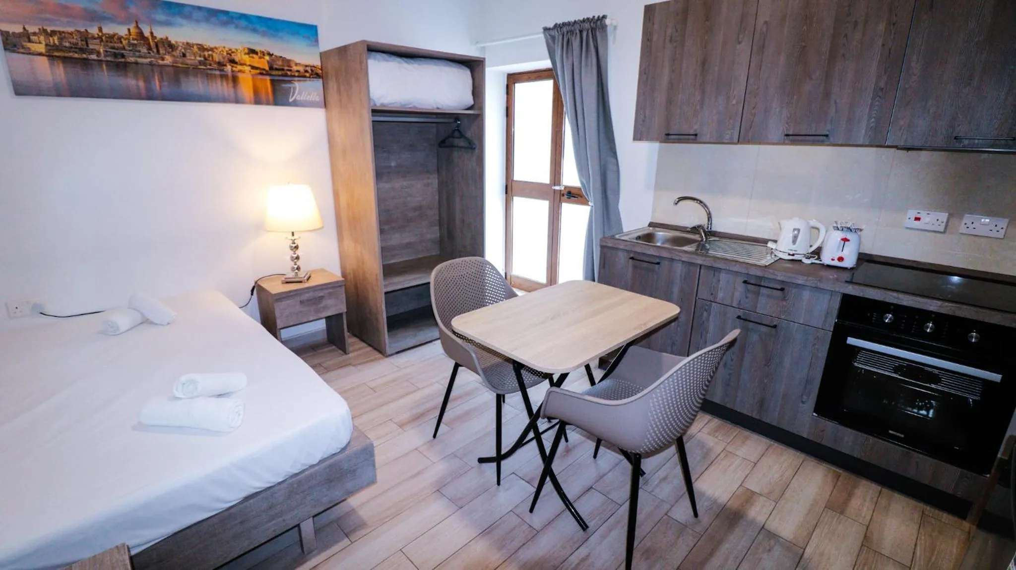 Kitchen or kitchenette, Bed in Napoli Suites Studios Aparthotel