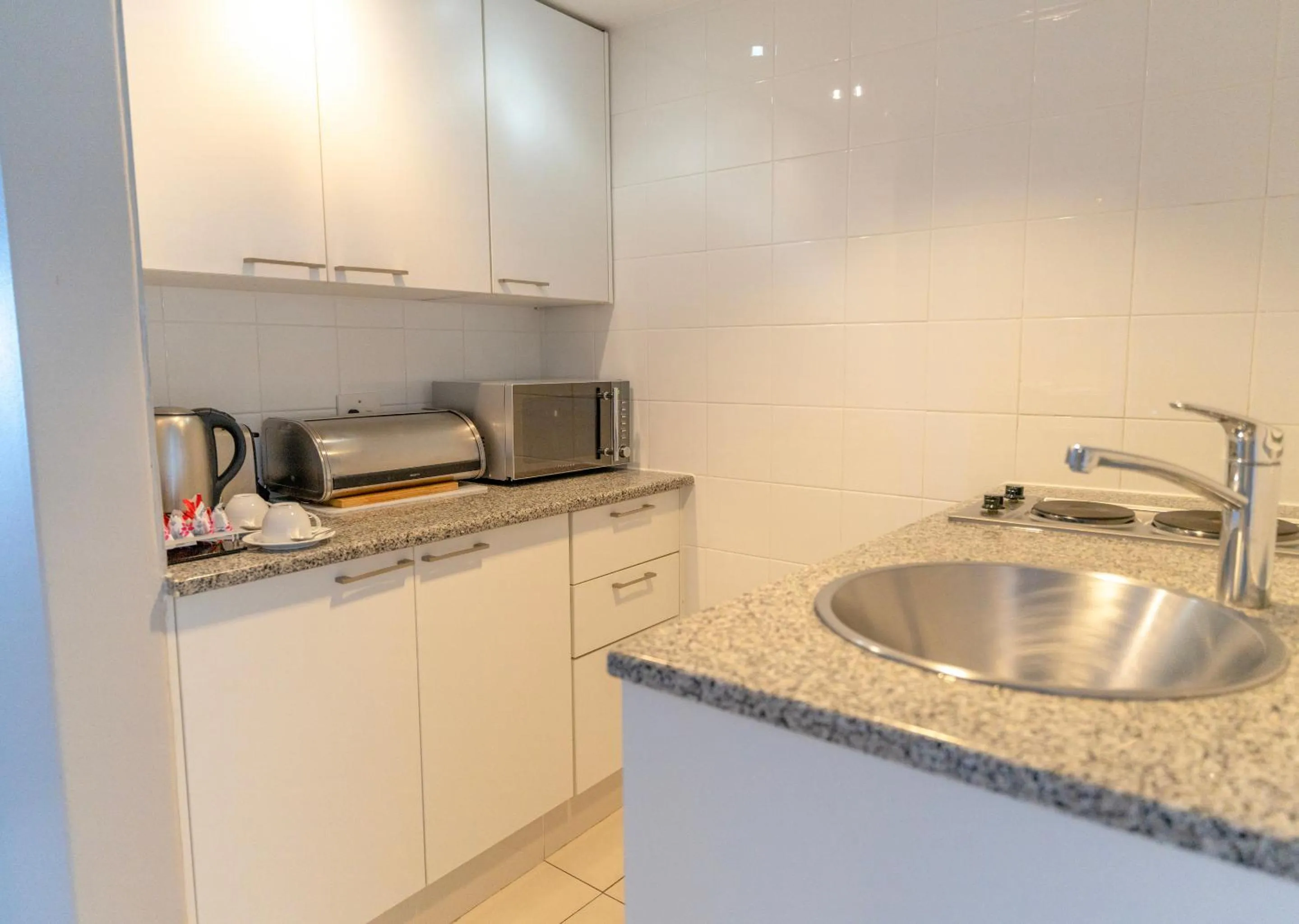 Kitchen or kitchenette in Peninsula All Suite Hotel by Dream Resorts