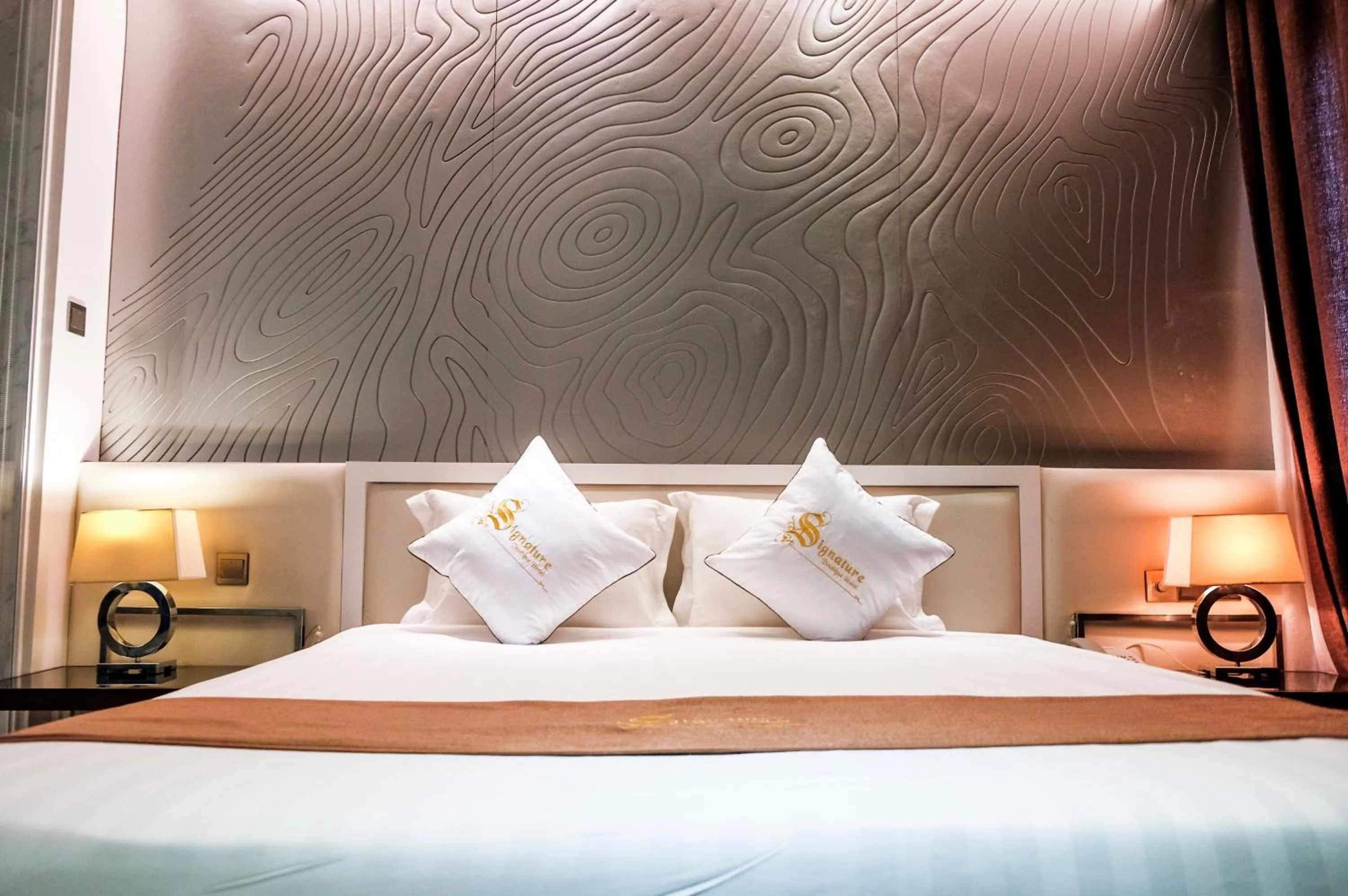Bed in Signature Boutique Hotel