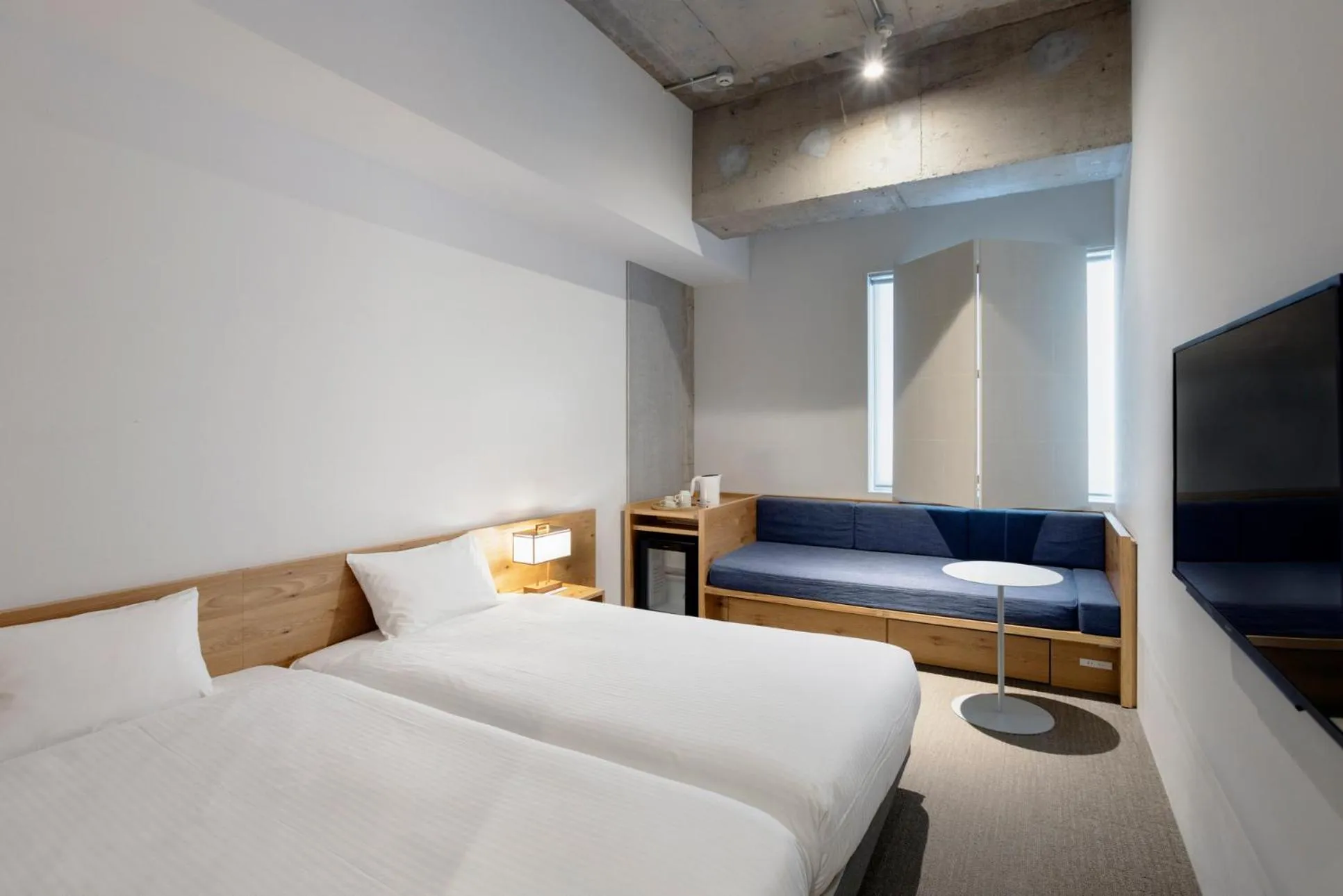 Bed in TSUGU Kyoto Sanjo by THE SHARE HOTELS