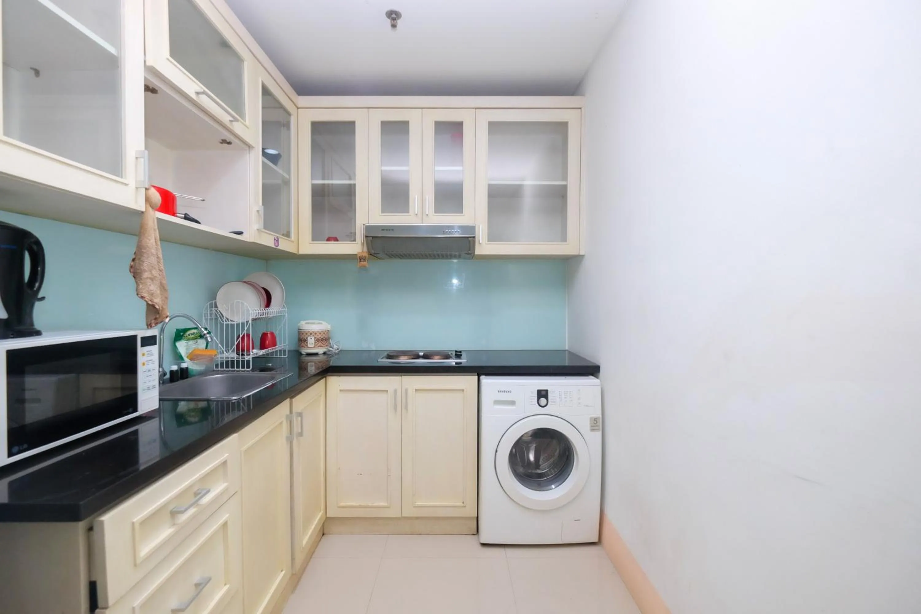 Kitchen or kitchenette in Best and Homey 2BR Taman Sari Semanggi Apartment By Travelio