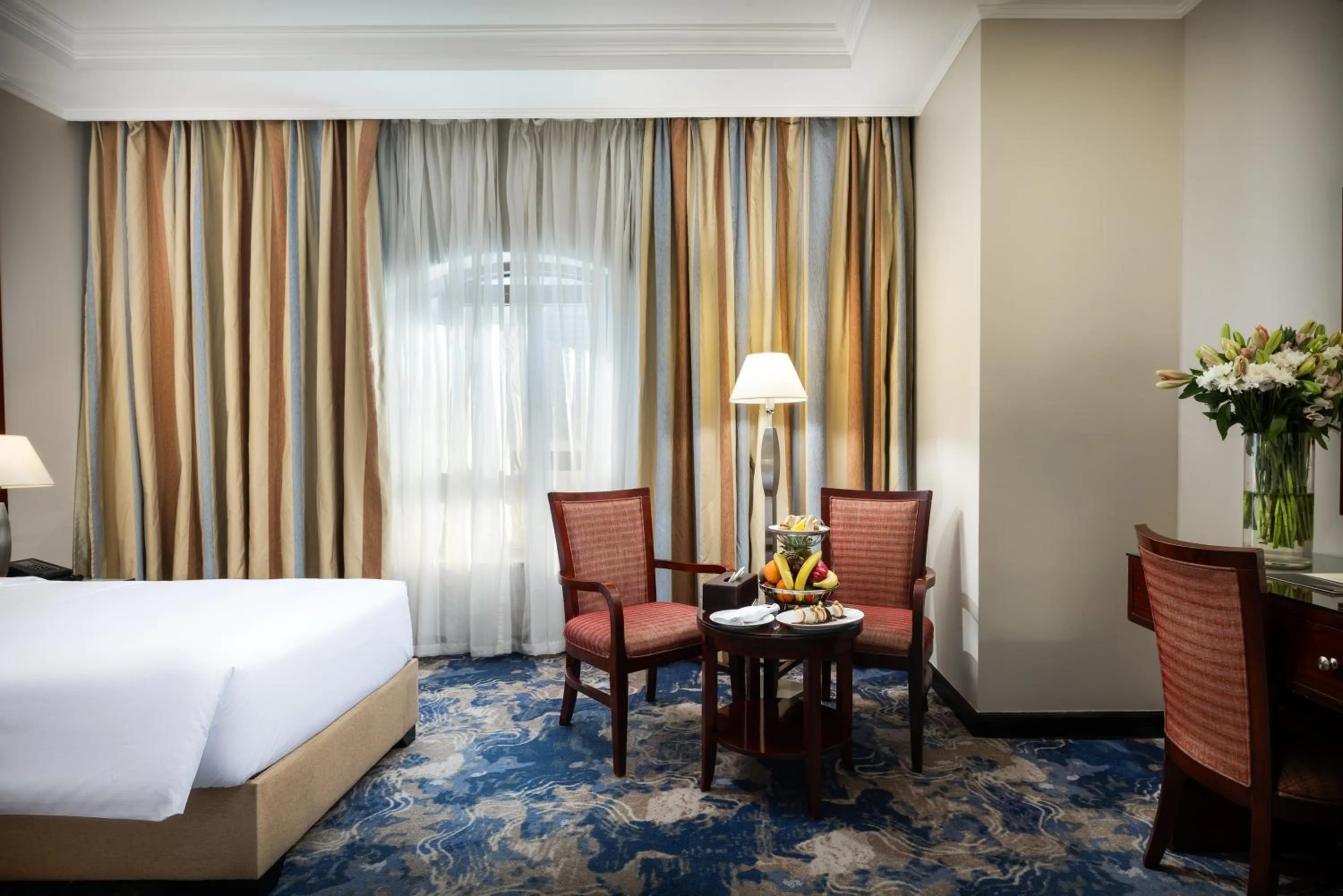 Living room, Bed in Emaar Royal Hotel